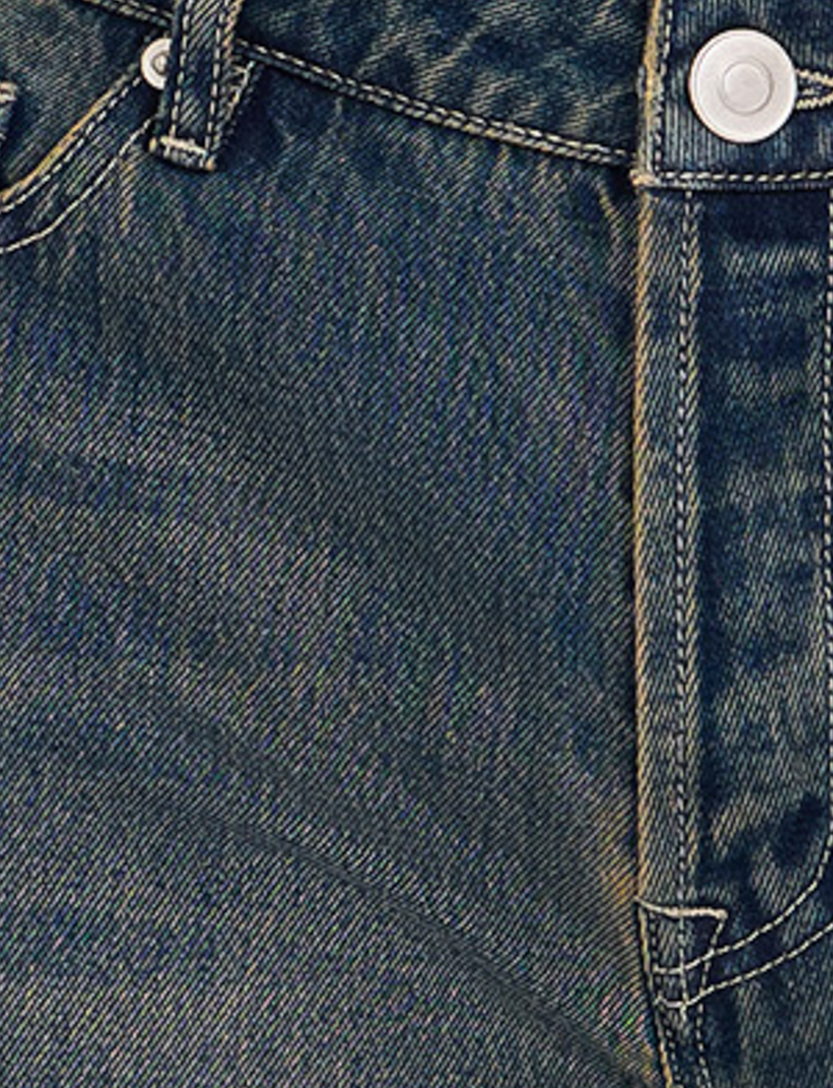 Close-up of TIGERMIST FELIX JEAN - BLUE : MID WASH shows the blue denim’s waistband, metal button, belt loop, and yellow stitching seam, highlighting the fabric texture and weave in detail.