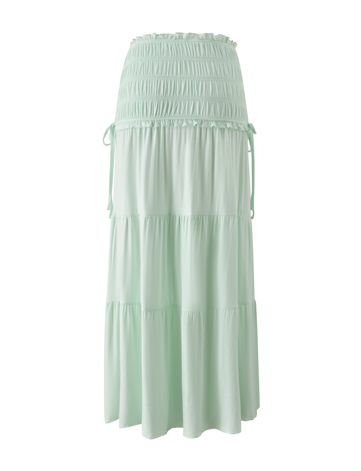 The DENALI MAXI SKIRT - SOFT MINT by TIGERMIST is a flowy modal maxi skirt with a wide shirred waistband, tiered silhouette, subtle ruffles, and side ties.