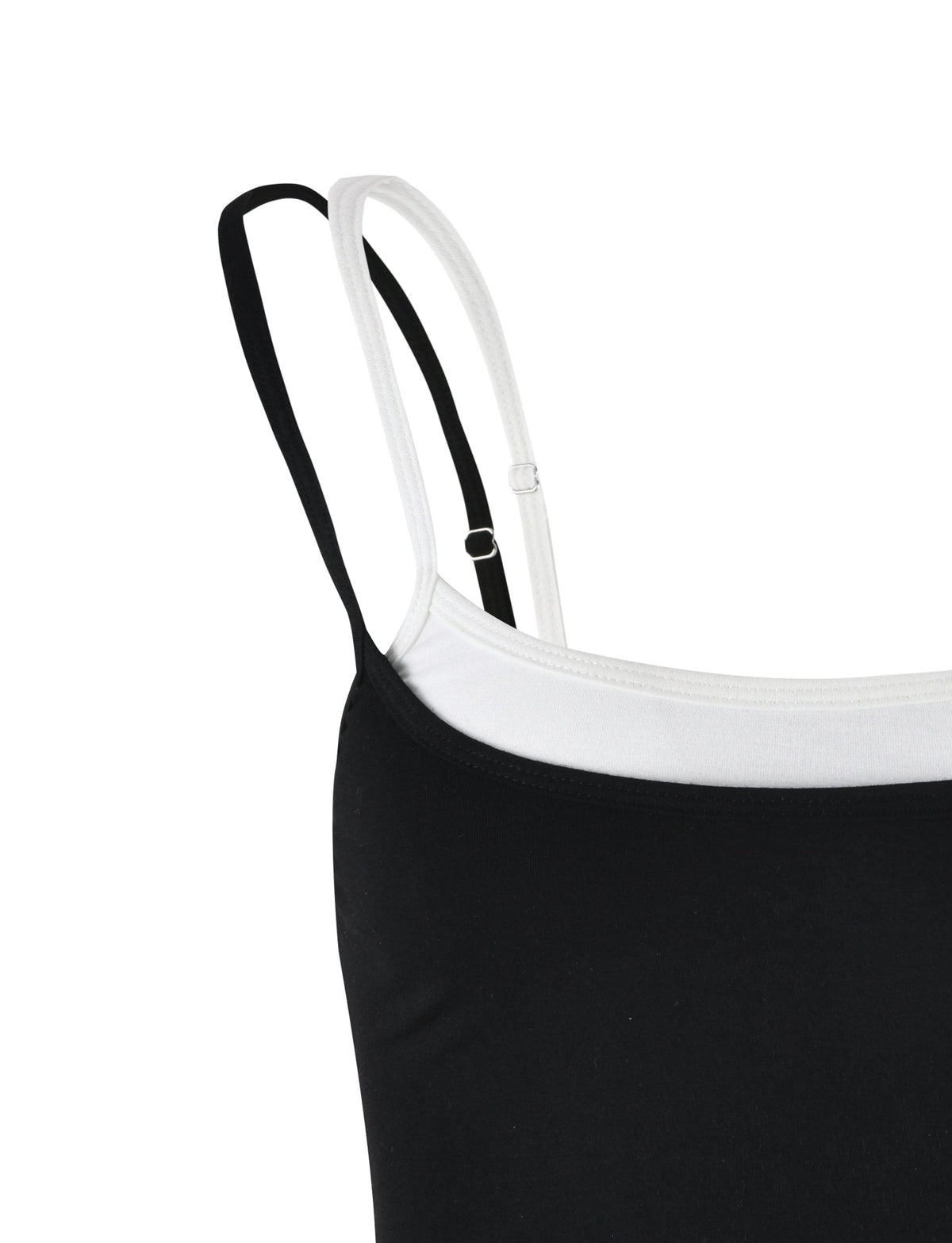 Close-up of the ADAIR TOP by TIGERMIST, featuring white and black spaghetti straps. The neckline displays a dual-layered fabric design, with the outer layer in black and the inner layer in white. The image highlights the simplicity and elegance of this TIGERMIST garment's design.