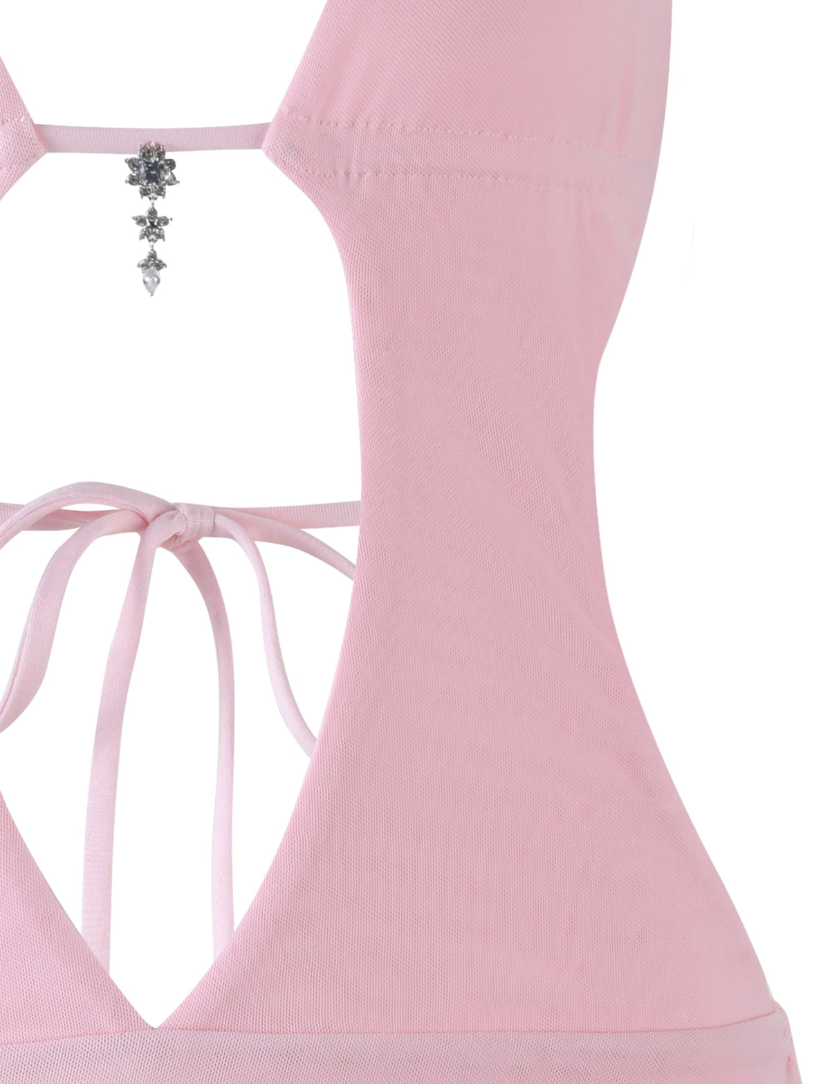Close-up of the back of the TIGERMIST ESHA DRESS - PINK in baby pink, featuring a halter neckline with thin ties, a cutout design, and a silver star-shaped chain accessory for added shine to this chic mini look.