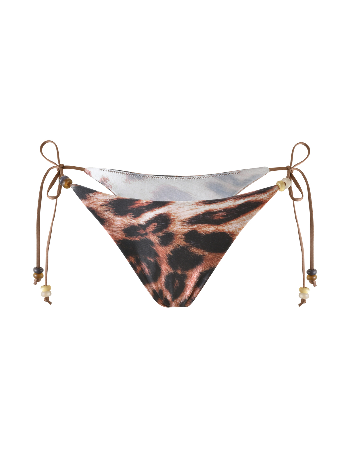 The FINLEA BIKINI BOTTOM by TIGERMIST in Leopard Haze features a cheeky cut, brown side ties with beaded shell accents, and is shown against a white background.