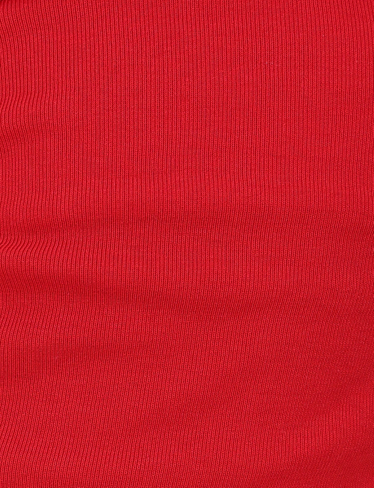 Close-up of the HARRIETT RIB TUBE TOP in red by TIGERMIST. The ribbed texture features vertical lines with subtle shading variations, adding depth and pattern. The fabric appears smooth, stretching horizontally to highlight its elegant strapless style.