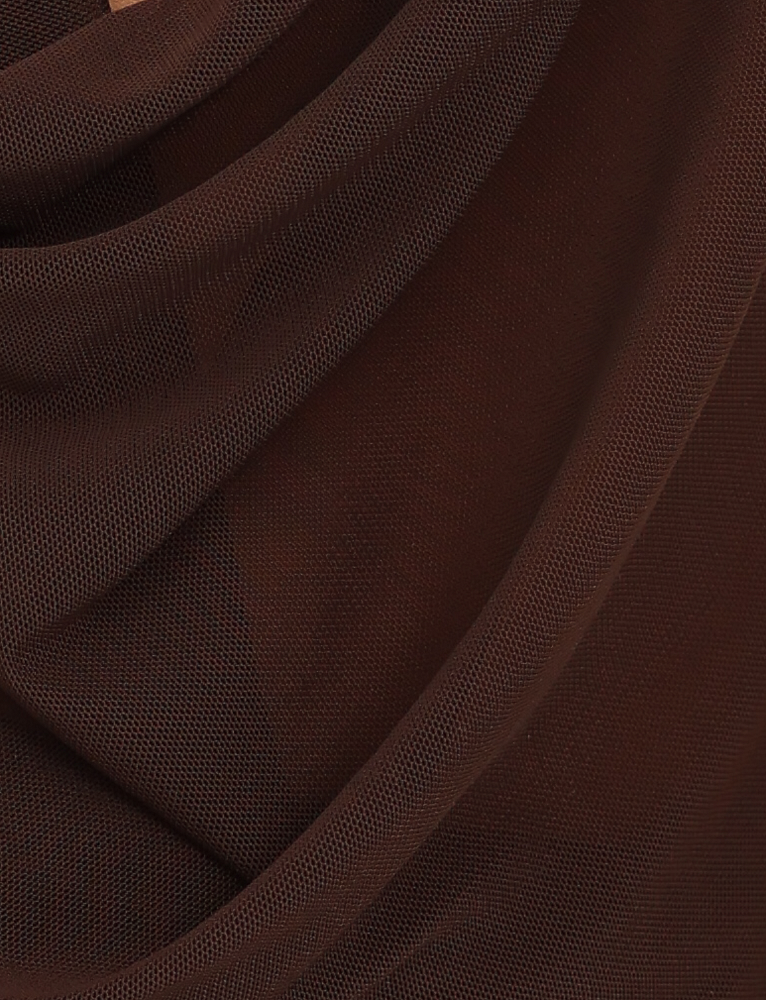 Close-up of TIGERMIST’s MAKENA TWO-PIECE TOP - BROWN : CHOCOLATE, featuring chocolate brown mesh fabric draped in soft folds to showcase its fine texture and sheer quality—ideal for a sultry look.