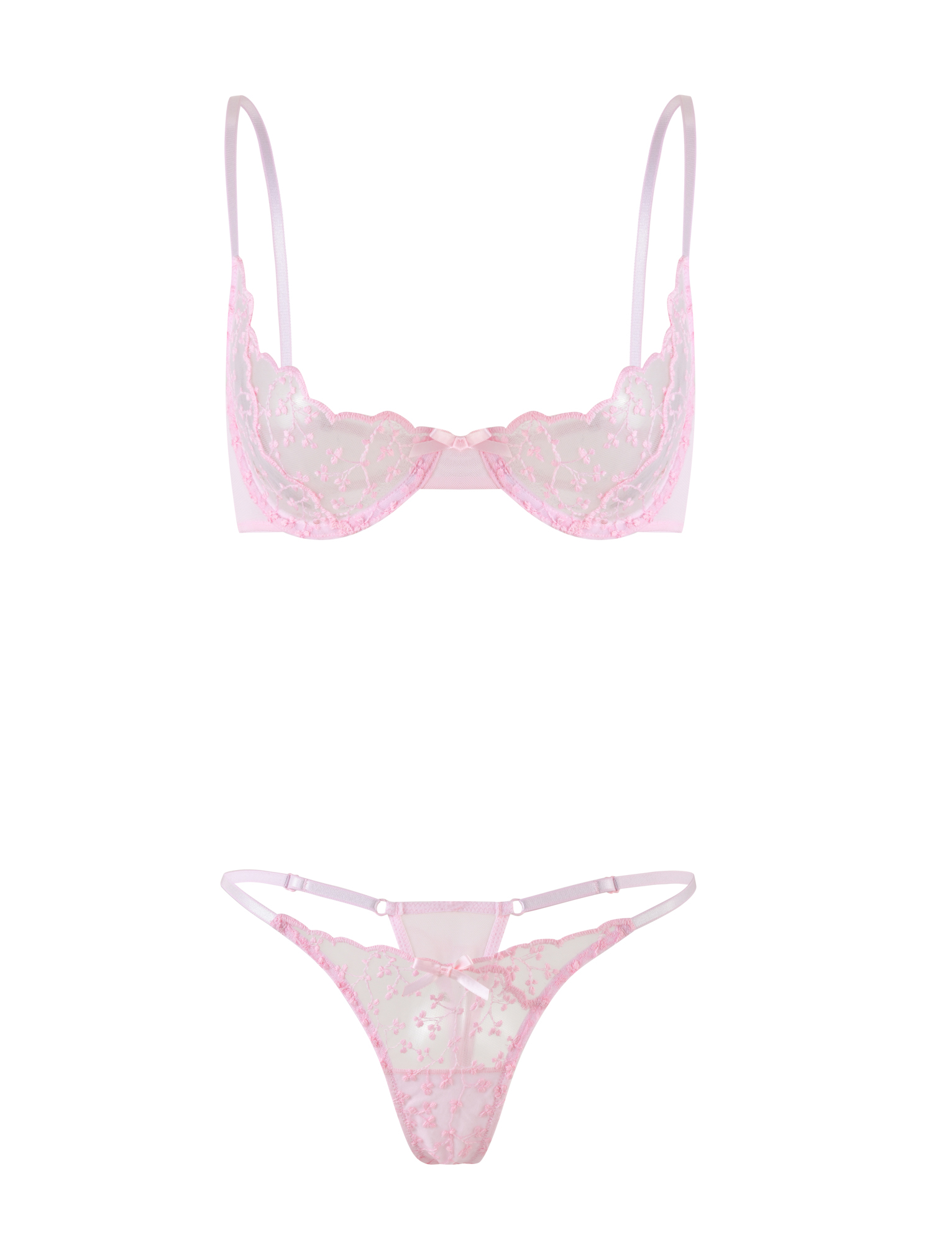 The TALIYAH SET - PINK by TIGERMIST is a baby pink lace lingerie set featuring a sheer, floral-embroidered bra with thin straps and a matching g-string with coordinating embroidery and delicate strap accents.