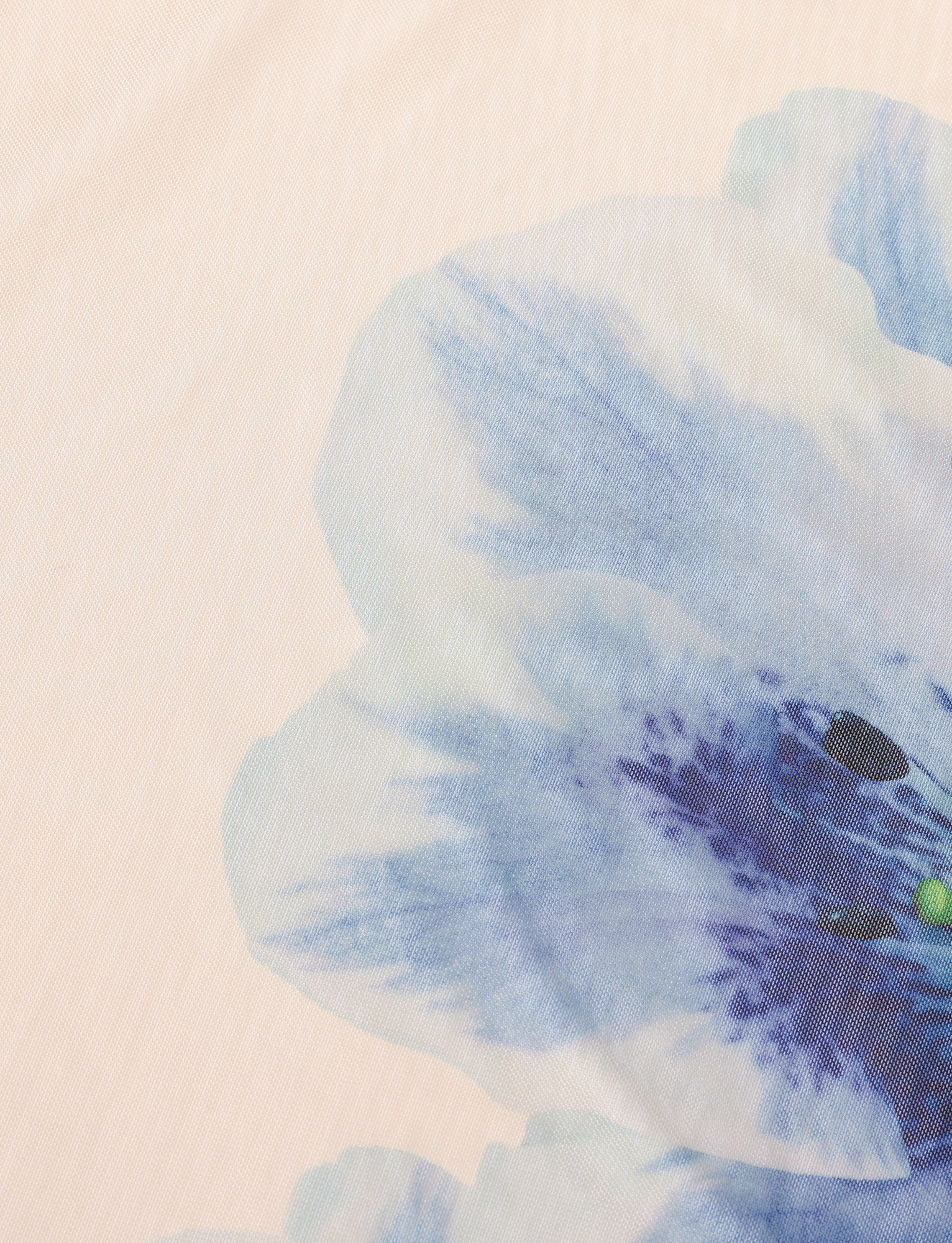 A close-up of the BROOKS DRESS by TIGERMIST in white and cream, featuring a soft beige background with light blue and purple watercolor-style floral print—ideal for a mesh dress with delicate details.
