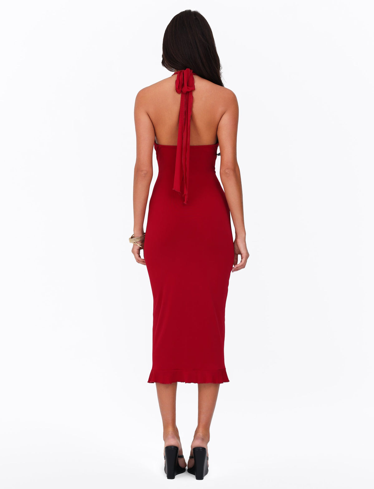 A rear view features a woman in the TIGERMIST GRANGER MIDI DRESS - RED in cherry red, showcasing a sleeveless halter-neckline design. Her long dark hair cascades down her back as she stands poised in high-heeled black shoes against a plain white background.