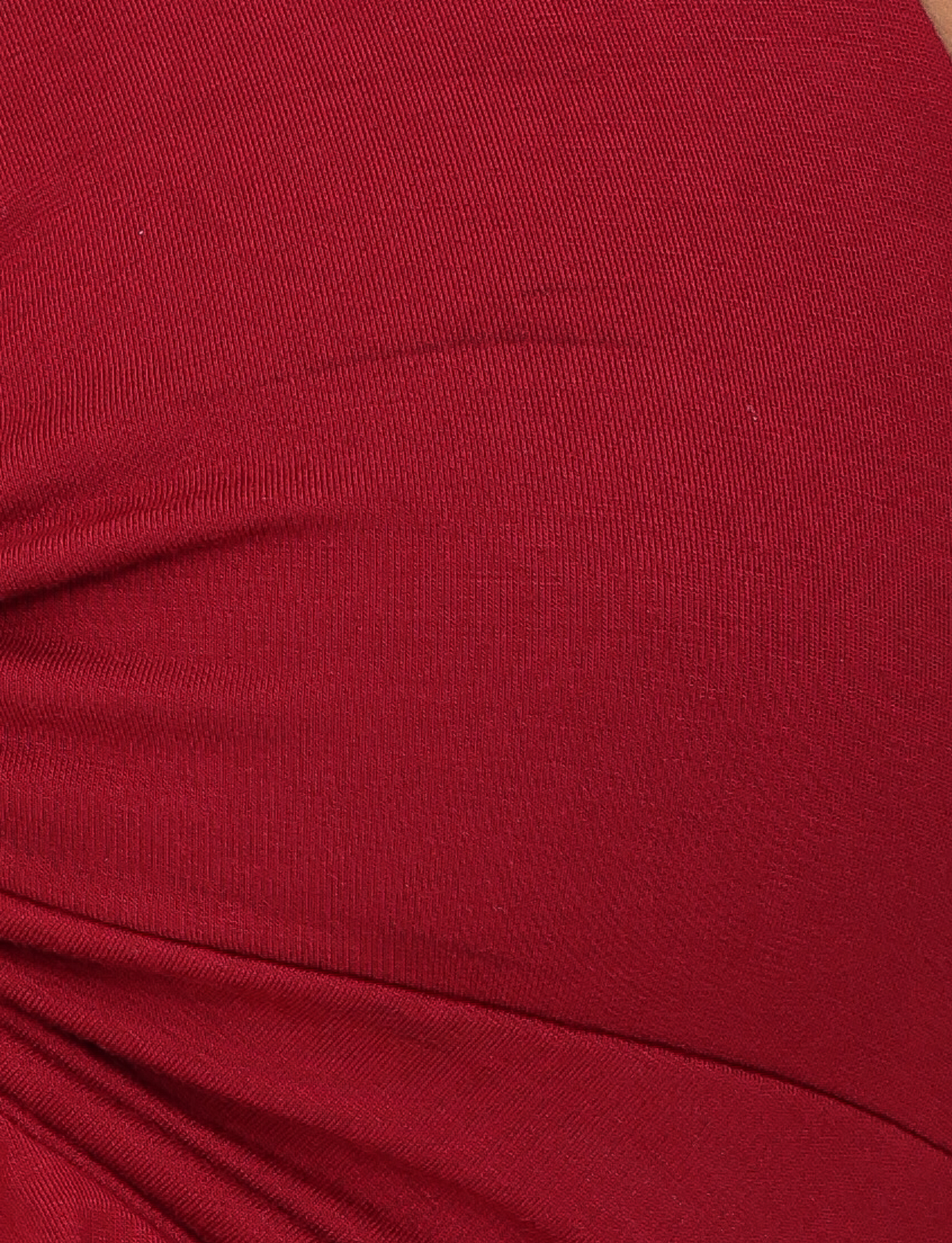 Close-up of the red fabric on the KATYA HALTER TOP by TIGERMIST, showing visible stitching and gathered folds for a textured look.