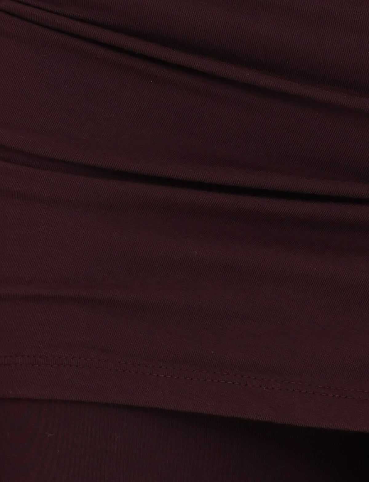Close-up view of the LEILANI PANT - BROWN : CHOCOLATE from TIGERMIST, showcasing a gathered and layered texture in a dark brown hue. The high-stretch fabric appears soft and pliable, with visible stitching along the lower edge.