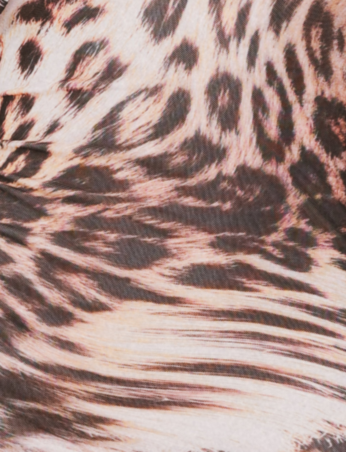 Close-up of the TIGERMIST ALLIRA MESH MINI DRESS 2.0 - NEUTRAL : LEOPARD : LEOPARD HAZE, showing brown, black, and beige animal print spots and stripes reminiscent of leopard fur.