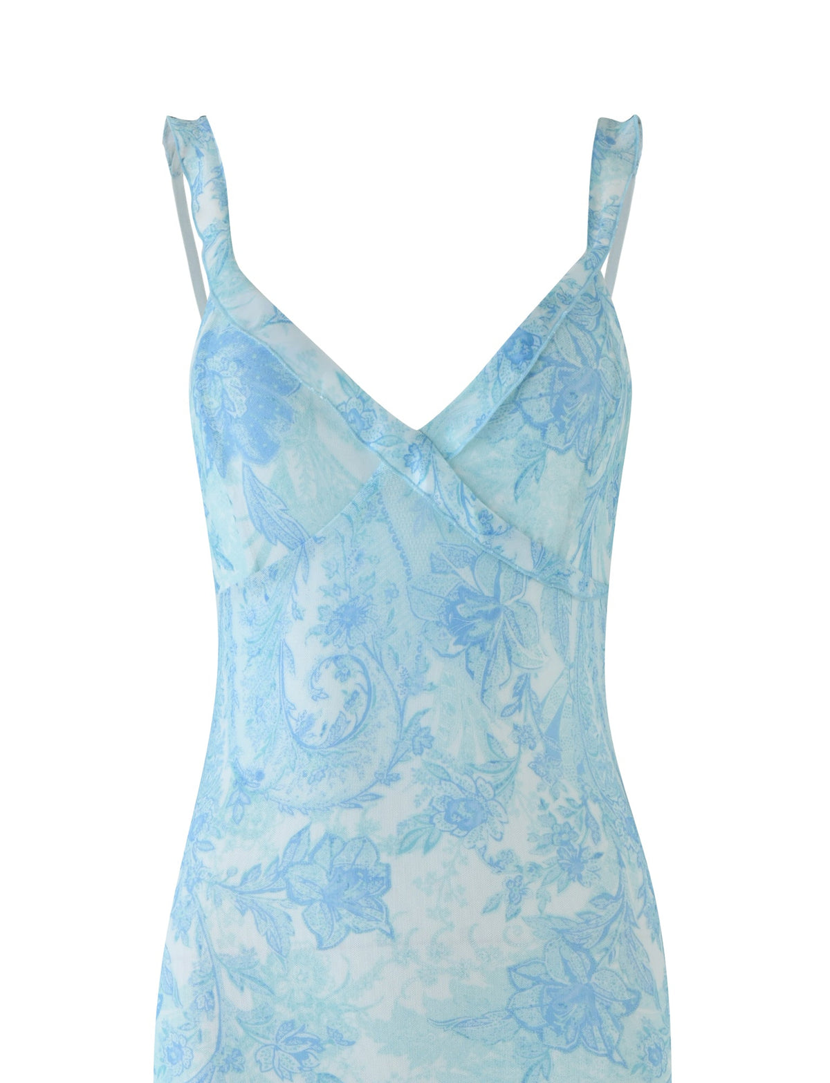 An up-close view of the GUILIANNA FRILL MAXI DRESS by TIGERMIST reveals its elegant light blue color, featuring a V-neckline and delicate spaghetti straps. The fabric is adorned with a sophisticated floral pattern in blue and white, imparting an airy elegance, while an asymmetric frill adds a whimsical touch to the design.