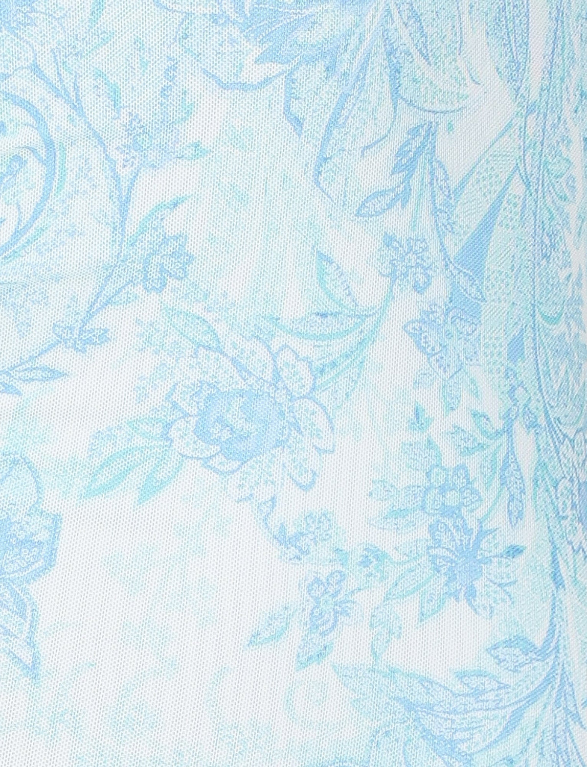 The GUILIANNA FRILL MAXI DRESS by TIGERMIST boasts a delicate light blue floral pattern with intricate designs set against a white fabric background. The frill shoulder straps add an elegant touch, while the asymmetric frill detail enhances its graceful appearance.