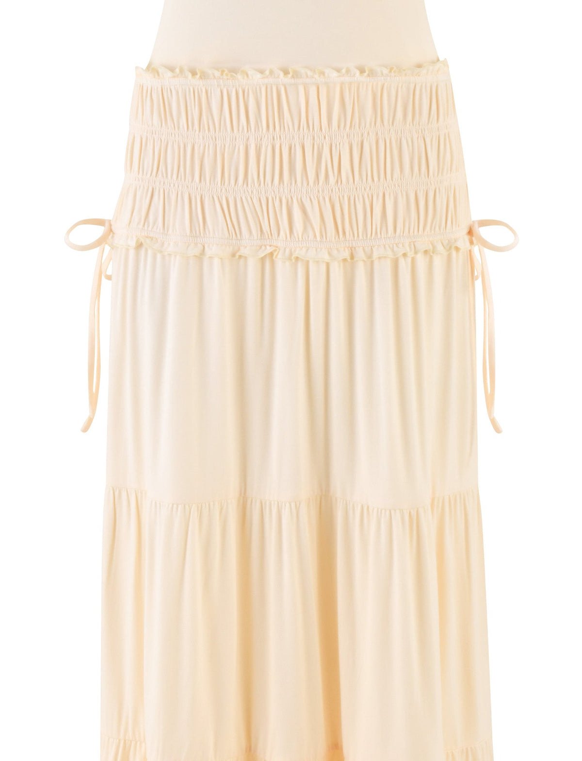 The DENALI HALTER DRESS in Bone by TIGERMIST features a cream-colored, tiered silhouette with gathered waist ruching and side bows, crafted from buttery, lightweight jersey for a flowy look.