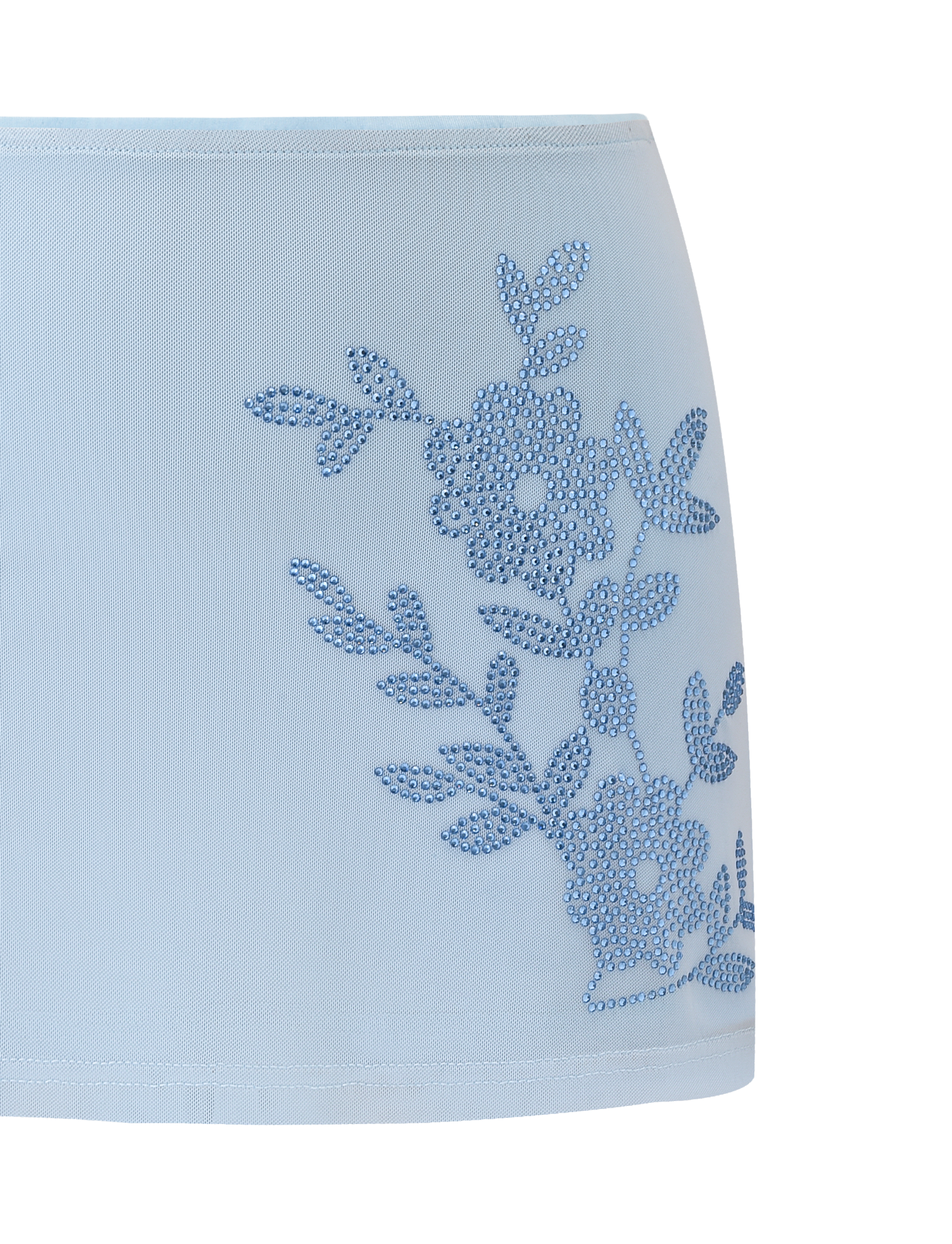 The OCTAVIA MINI SKIRT - BABY BLUE by TIGERMIST is a light blue mini skirt with small blue floral stud embellishments on the front right side, crafted from smooth, slightly sheer fabric.