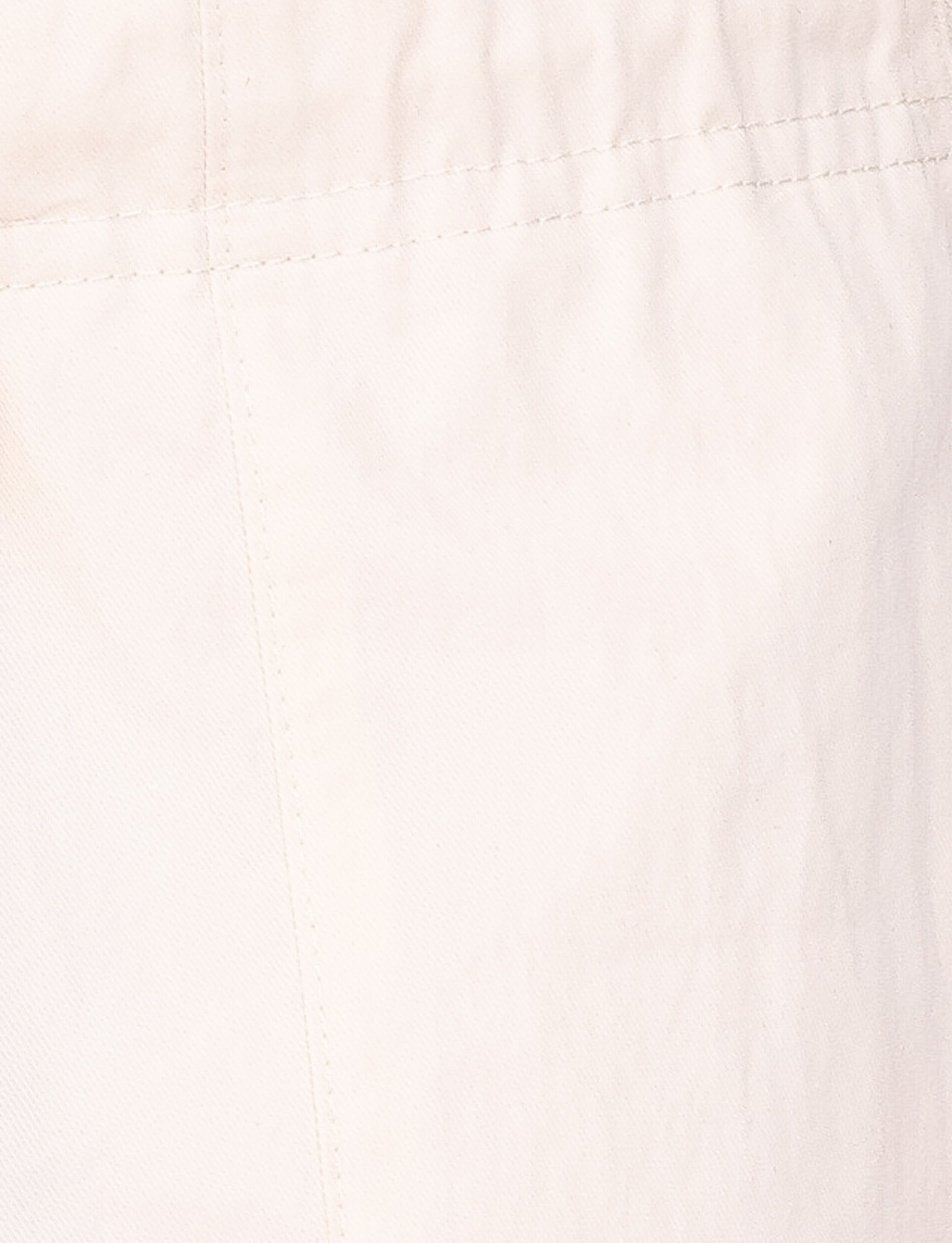 Close-up of TIGERMIST's HERMIONE PANT in Soft Butter yellow, showing visible stitching and seams on slightly wrinkled fabric for a comfy, stylish look.