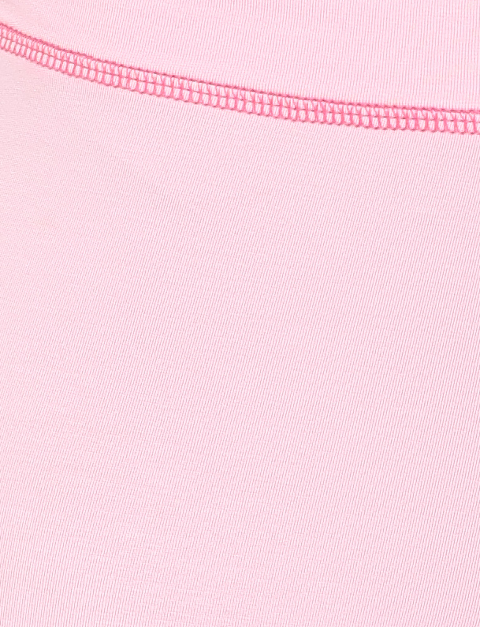 Close-up of TIGERMIST BLAYZE PANT in soft pink, showing a visible seam stitched with darker pink thread diagonally across the fabric. The texture and weave are clearly shown.