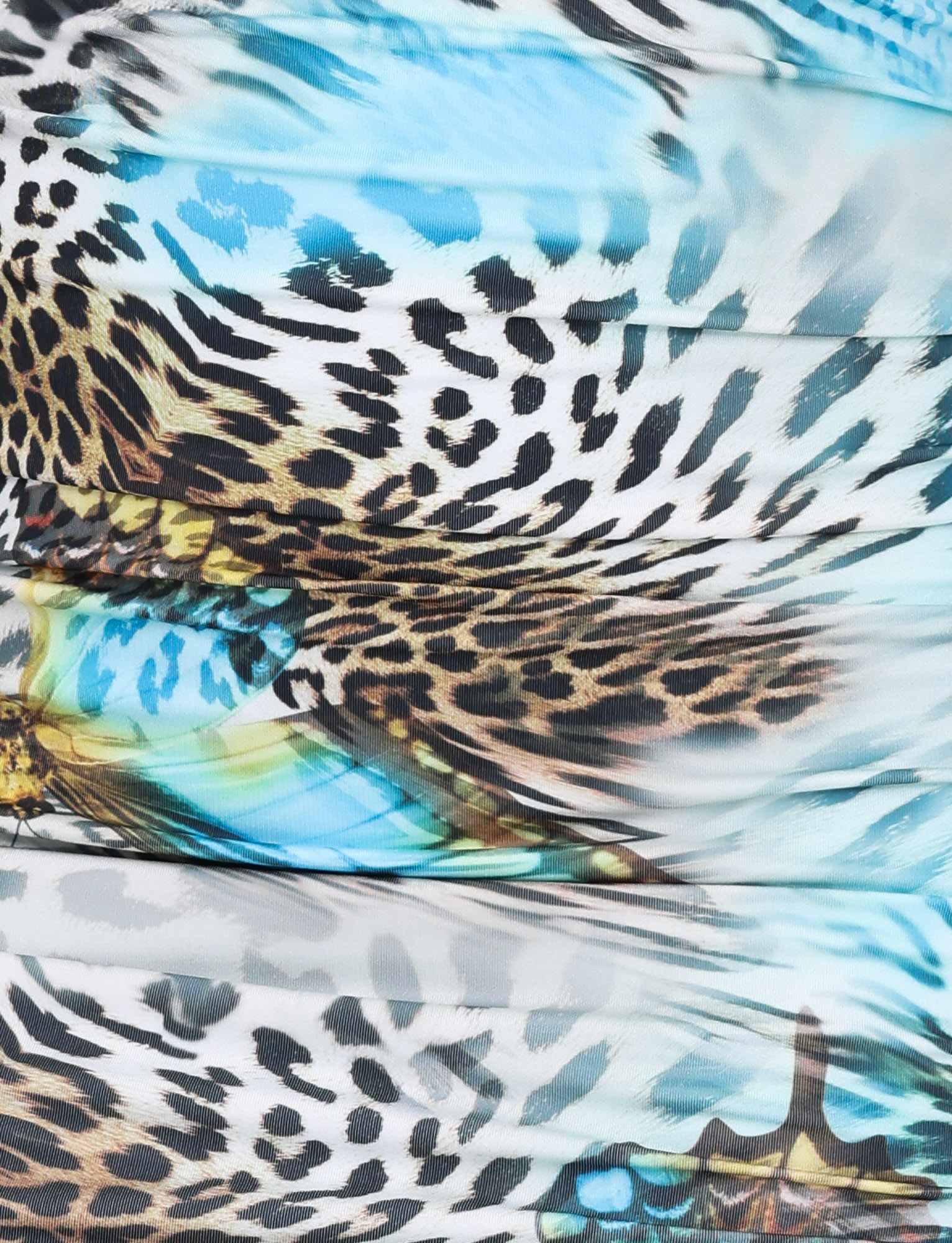 A detailed view of TIGERMIST's FINLEA MINI SKIRT - MULTI reveals a vibrant butterfly-animal pattern in black, brown, white, and turquoise—ideal for an A-line mini skirt or unique lace waistband detail.