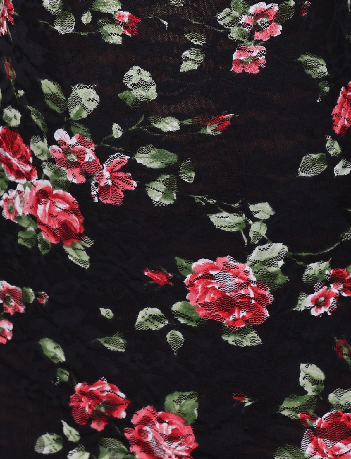 Close-up of TIGERMIST’s ANDEE MINI DRESS in BLACKROSE: black stretch lace fabric with a floral pattern of pink and red roses, green leaves, and delicate white accents.