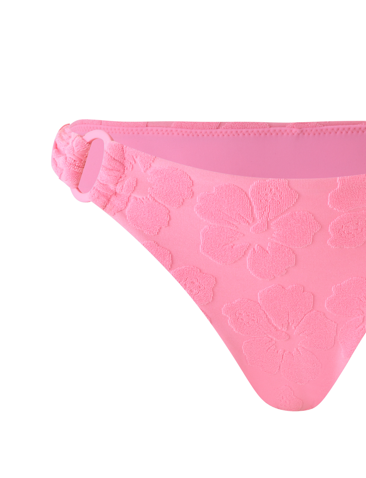 The TIGERMIST FIORA BIKINI BOTTOM in baby pink features floral embossing, a fabric-covered ring on one side, and a soft seamless waistband, shown against a matching pink background.