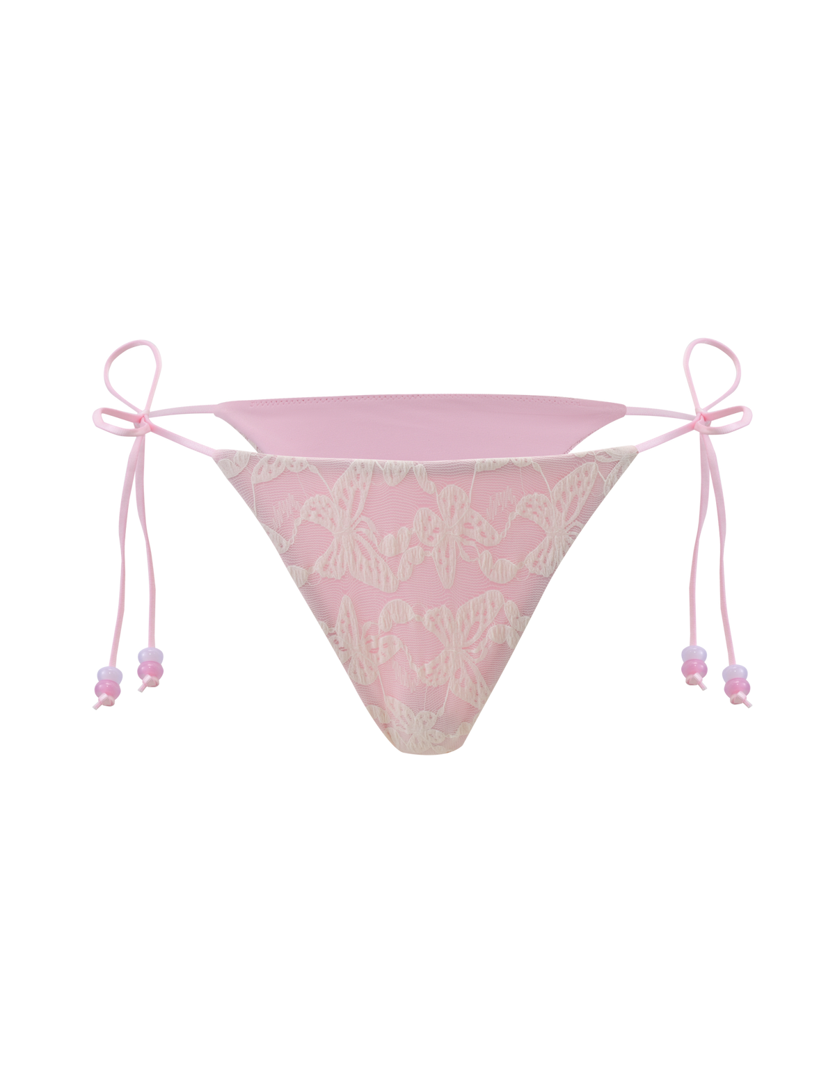 The TIGERMIST BRIGITTE BIKINI BOTTOM in ivory lace features white butterfly patterns, pink ribbon side ties, and a cheeky bikini cut, shown against a pale pink background.