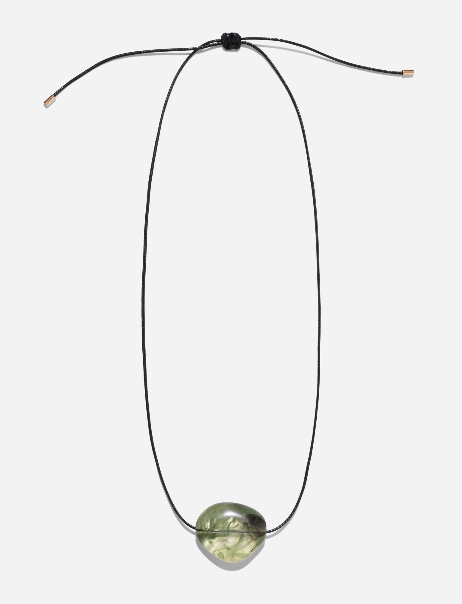 The SOLENE NECKLACE - GREEN by TIGERMIST features a minimalist black woven cord with an adjustable knot and a central oval translucent green stone pendant.