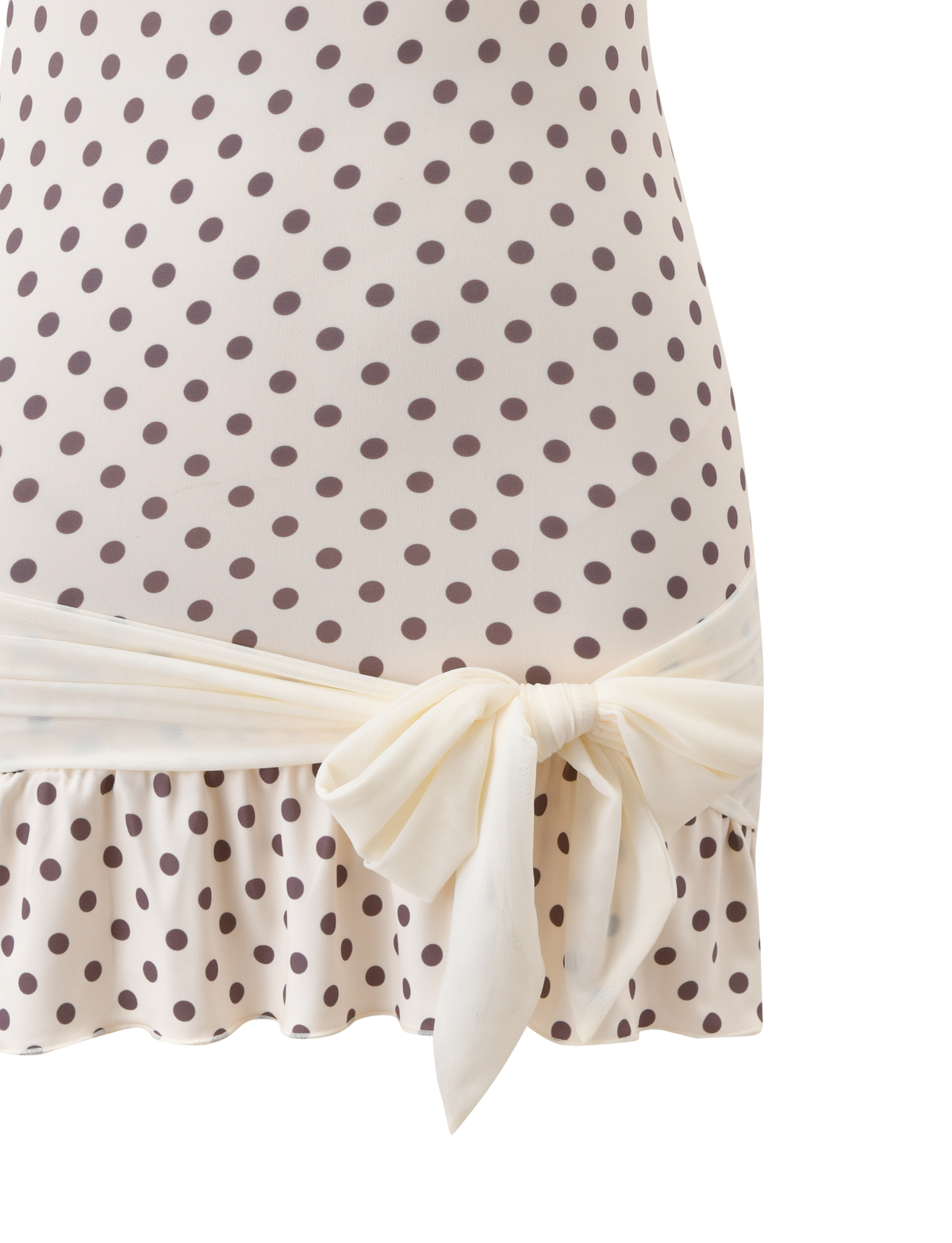 Close-up of the TIGERMIST TOVE MINI DRESS - WHITE POLKA DOT, a strapless bodycon mini with ruffle hem and a large cream bow at the waist.