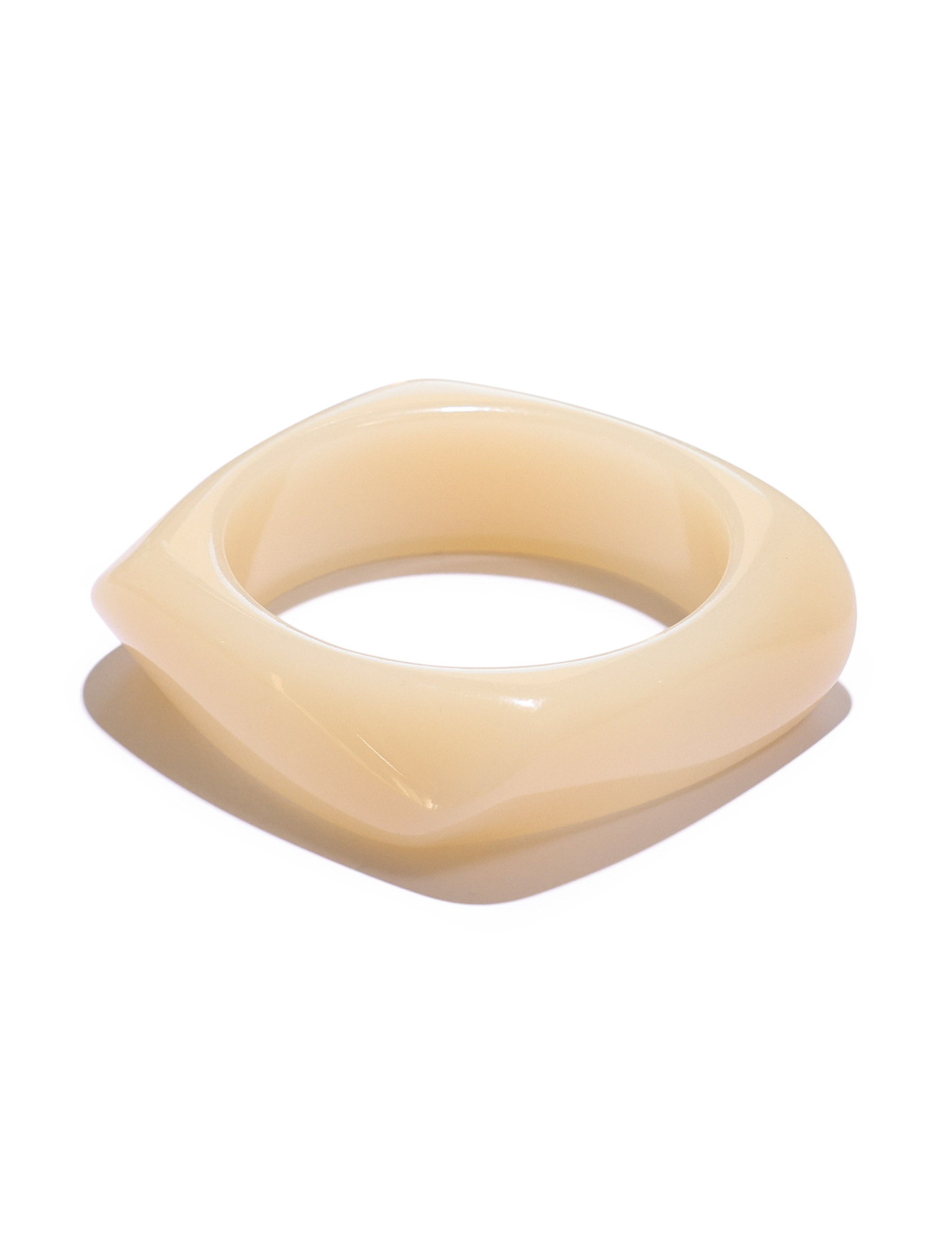 The TIGERMIST TIA CHUNKY 2PC RESIN BANGLE SET in cream and blue features glossy, marble-like bangles with rounded edges, displayed on a white surface and casting a soft shadow.