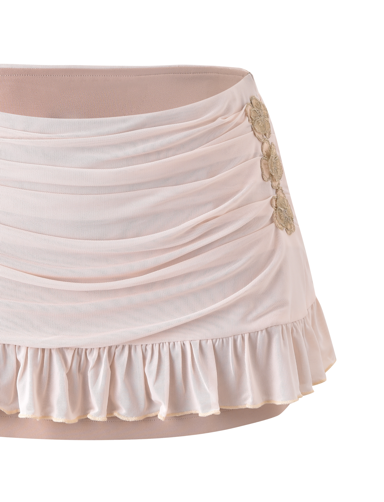 The TERESE FLORAL APPLIQUE SKIRT in tan by TIGERMIST features ruching, a ruffled hem, and three gold floral appliqués on one side, shown against a plain white background.