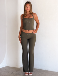Olive green KITTIE BUCKLE PANT - OLIVE halter top and matching low-rise flared pants, both featuring silver metal buckle detail at the center.