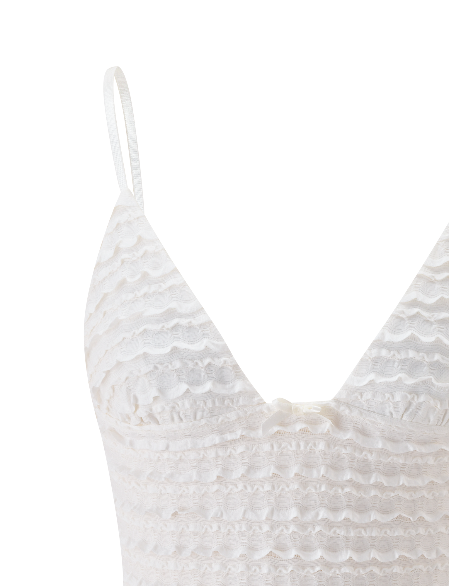 The ZORA TOP - CREAM by TIGERMIST features ruffle detailing, adjustable shoulder straps, and a small bow at the center chest, shown here against a plain white background.