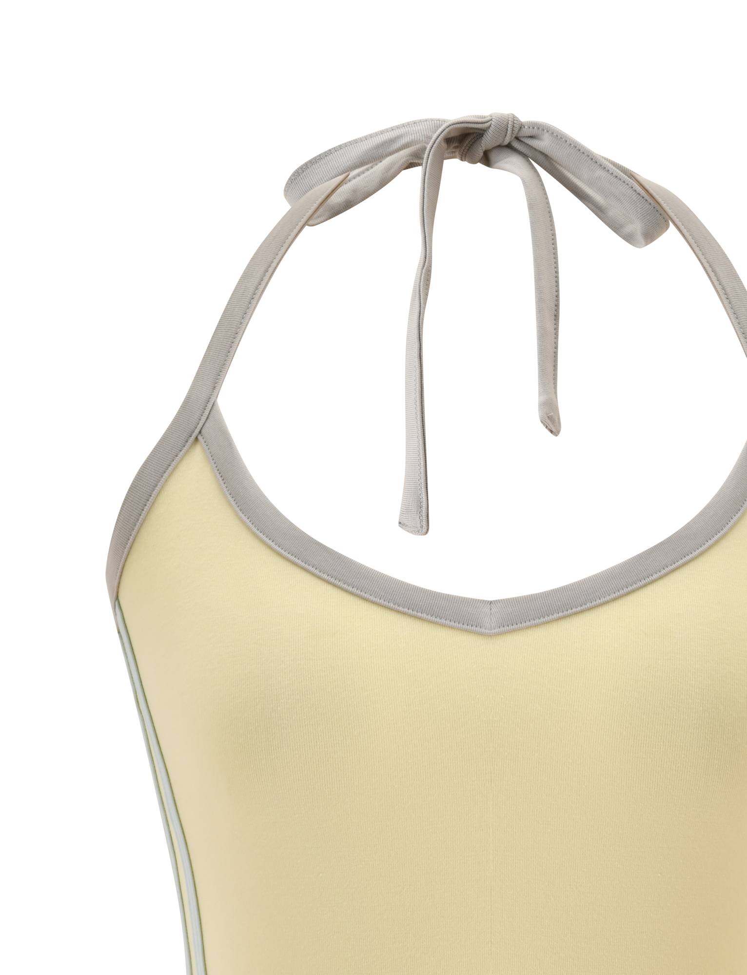 Close-up of the TIGERMIST ALYSIA TOP - BUTTER, a sleeveless yellow halter top featuring a wide light gray stripe along the v-neckline and neck ties. The smooth fabric contrasts against a plain white background.