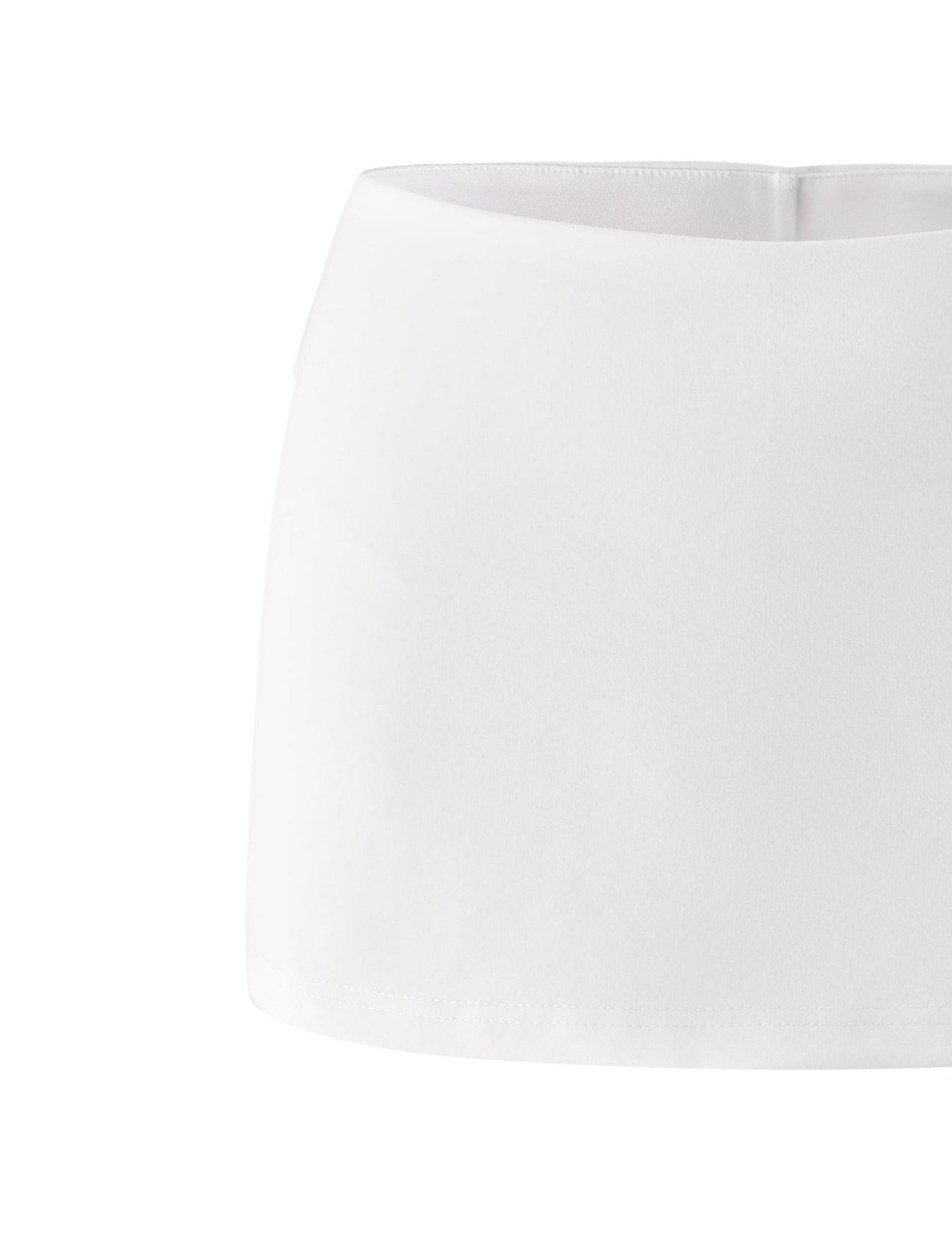 The VICTORIA MINI SKORT - IVORY from TIGERMIST is showcased against a white background, highlighting its minimalist straight cut and absence of visible embellishments or fastenings. Its low-rise silhouette and bodycon fit give it a sleek, modern look.