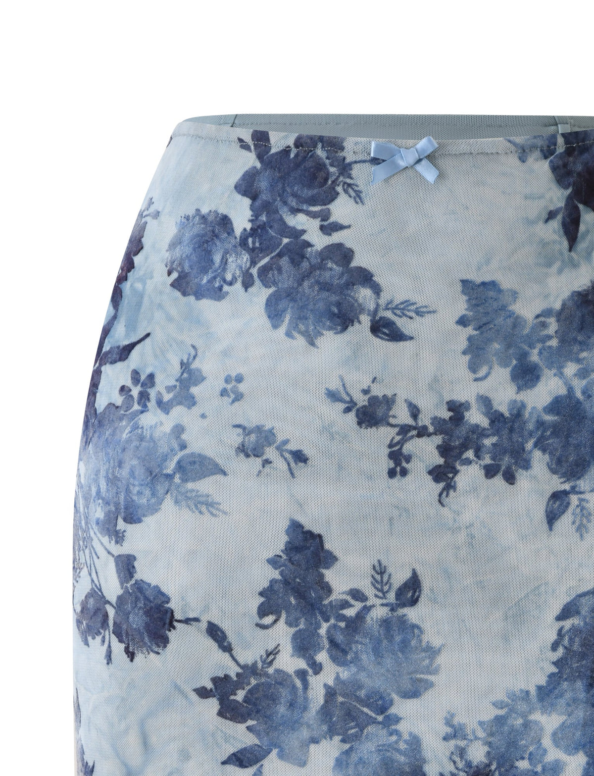 ELLIOT MIDI SKIRT - DUSTY BLUE in a 90′s column silhouette, featuring a dark blue floral print and a small bow at the center waist.