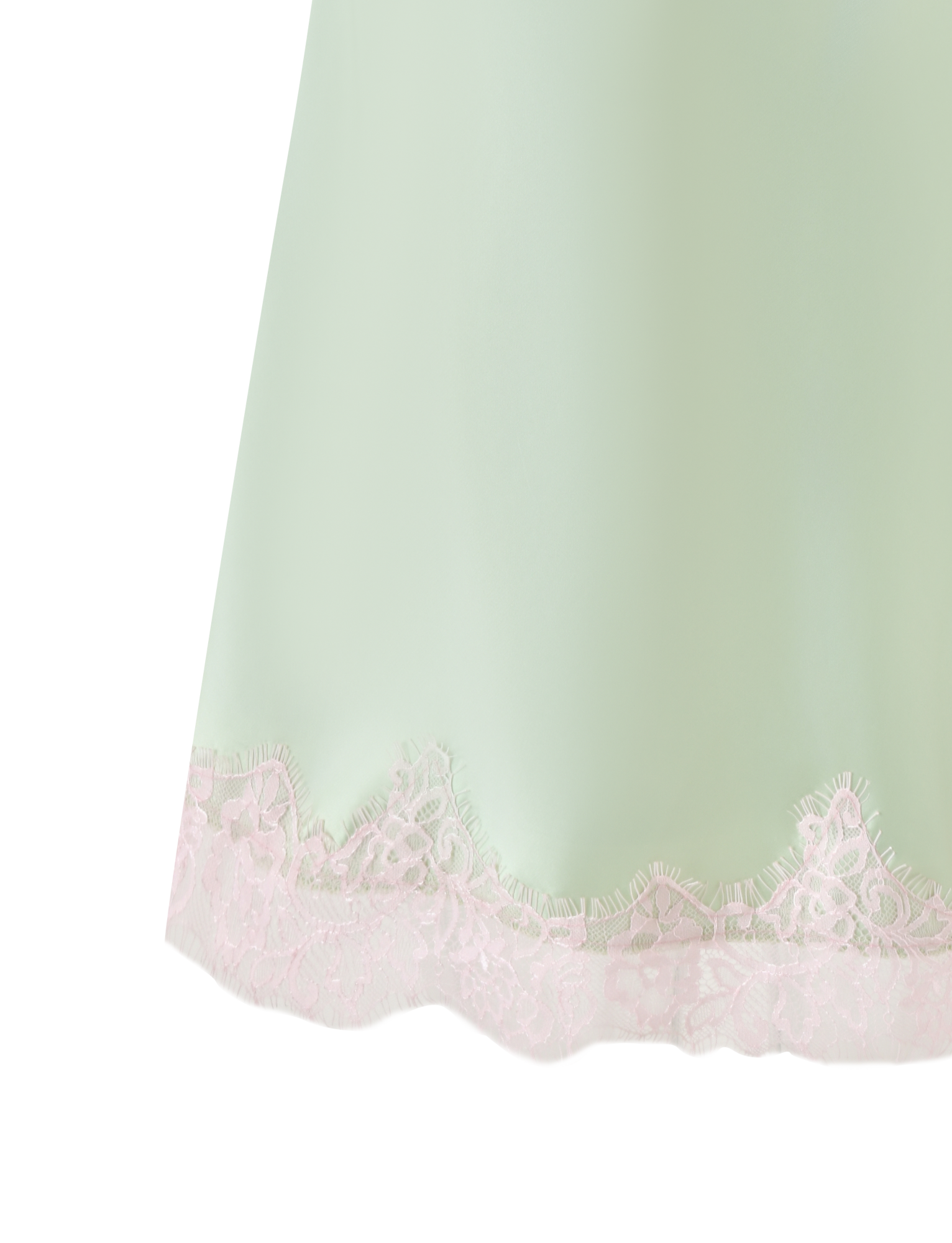 A close-up of the TIGERMIST MILYANA MINI DRESS in Pistachio, featuring green satin and a scalloped pink lace hem. The light mint fabric pops against a plain white background.