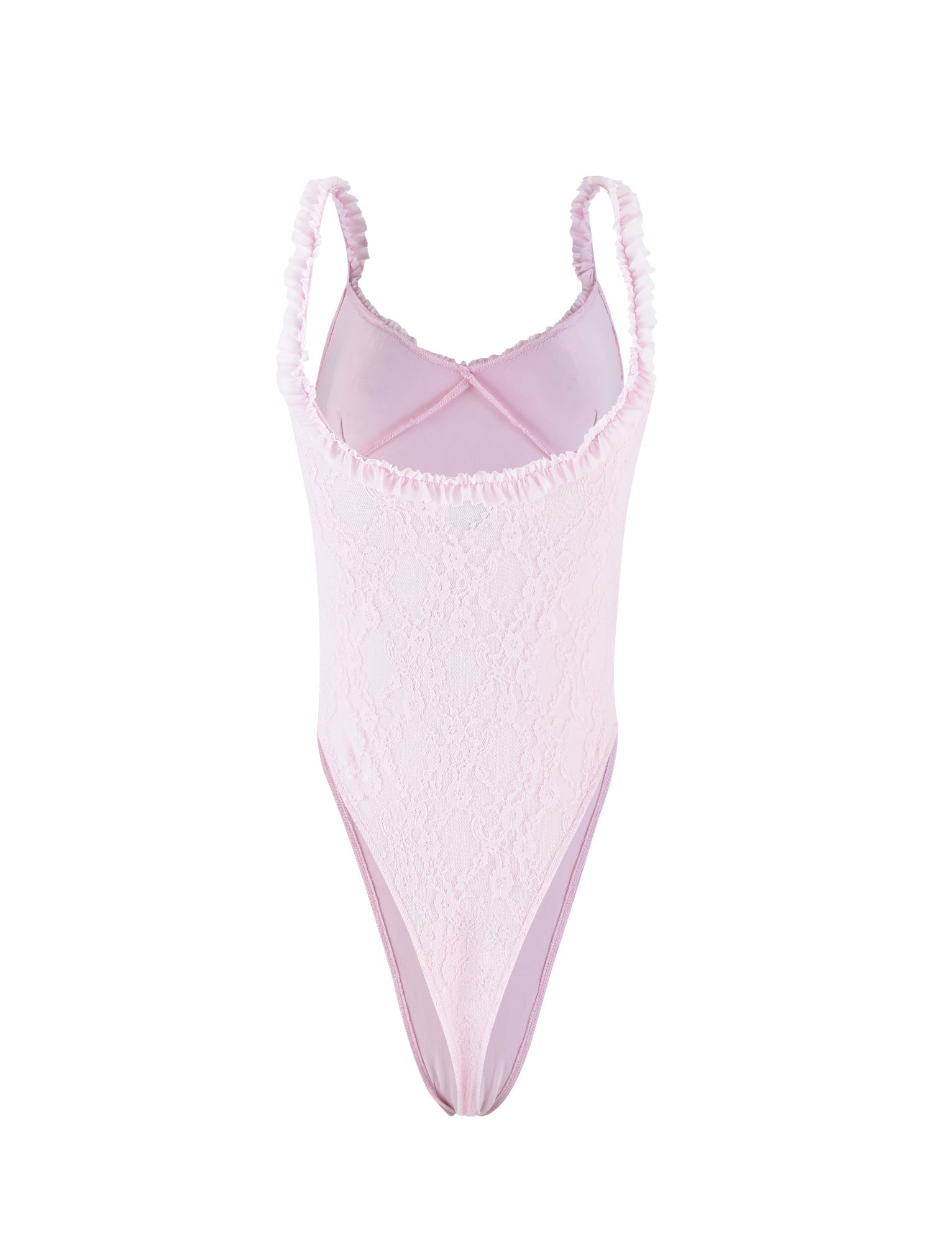 A pastel pink, lace bodysuit from TIGERMIST named DEJA BODYSUIT - PINK is arranged on a white background. The bodysuit features thin, ruffled straps, a subtle floral pattern, and a high-cut leg design. The delicate fabric and frills suggest a feminine and elegant style.