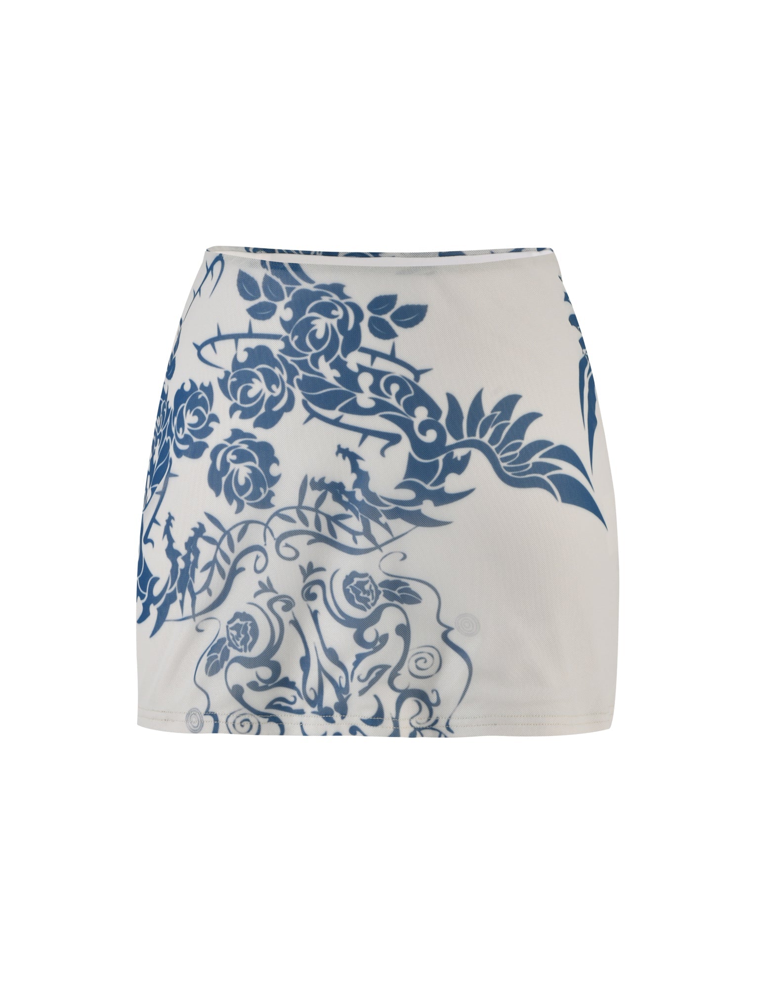 The FINOLA MESH MINI SKIRT - BLUE : TATTOO : TATTOO PRINT from TIGERMIST is a white mini skirt featuring an intricate blue floral and animal pattern. The design includes roses and various floral elements mixed with silhouetted animals, creating an ornate pattern across the fabric. The skirt boasts a smooth, fitted shape.