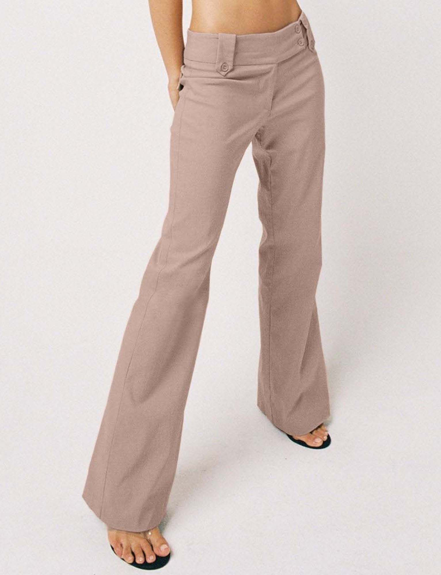 A person models the TIGERMIST KITTIE PANT - TAUPE, featuring a flared leg, paired with black open-toe sandals against a white background. Upper body not shown.