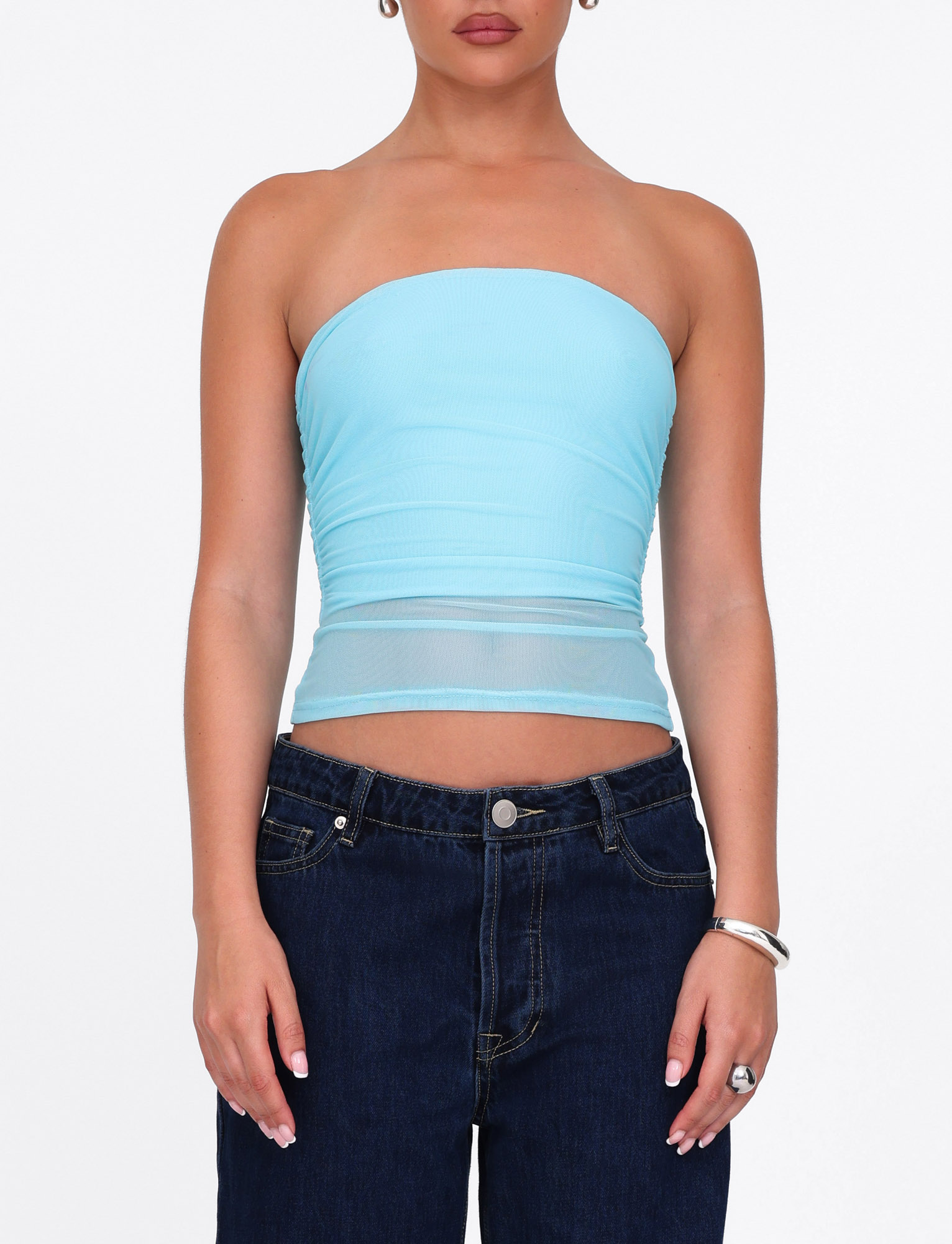 A person wears the TIGERMIST HARRIETT TUBE TOP in bright blue mesh with dark jeans, silver bracelet and ring, against a plain white background.