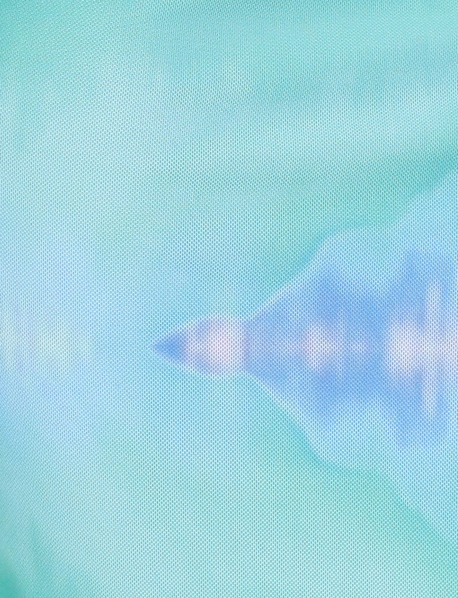 A blurred blue and white triangular form overlays a green-teal textured backdrop, echoing the abstract floral print of TIGERMIST's ARDON MAXI DRESS in Macro Floral: Blue Hibiscus.