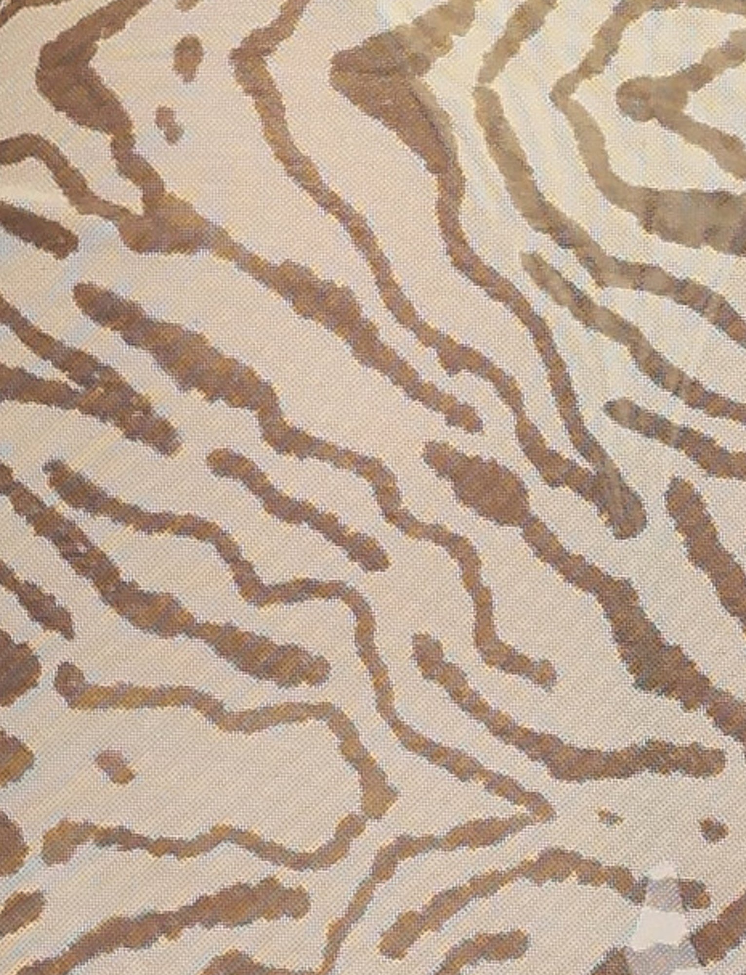 A close-up view of the PEACHY SARONG - YELLOW : ZEBRA from TIGERMIST showcases a fabric featuring an animal print pattern in varying shades of brown and beige. The design mimics the irregular stripes and spots typically found on leopards or tigers, rendered in a unique yellow zebra colourway. The texture appears woven and slightly textured.