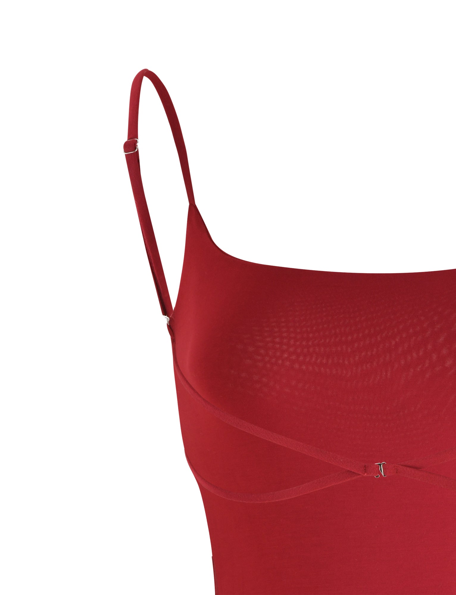 A close-up of a red Minerva Bodysuit by TigerMist, highlighting the left shoulder straps. The fabric appears smooth, and the bodysuit features a subtle, sleek design. The background is plain white.