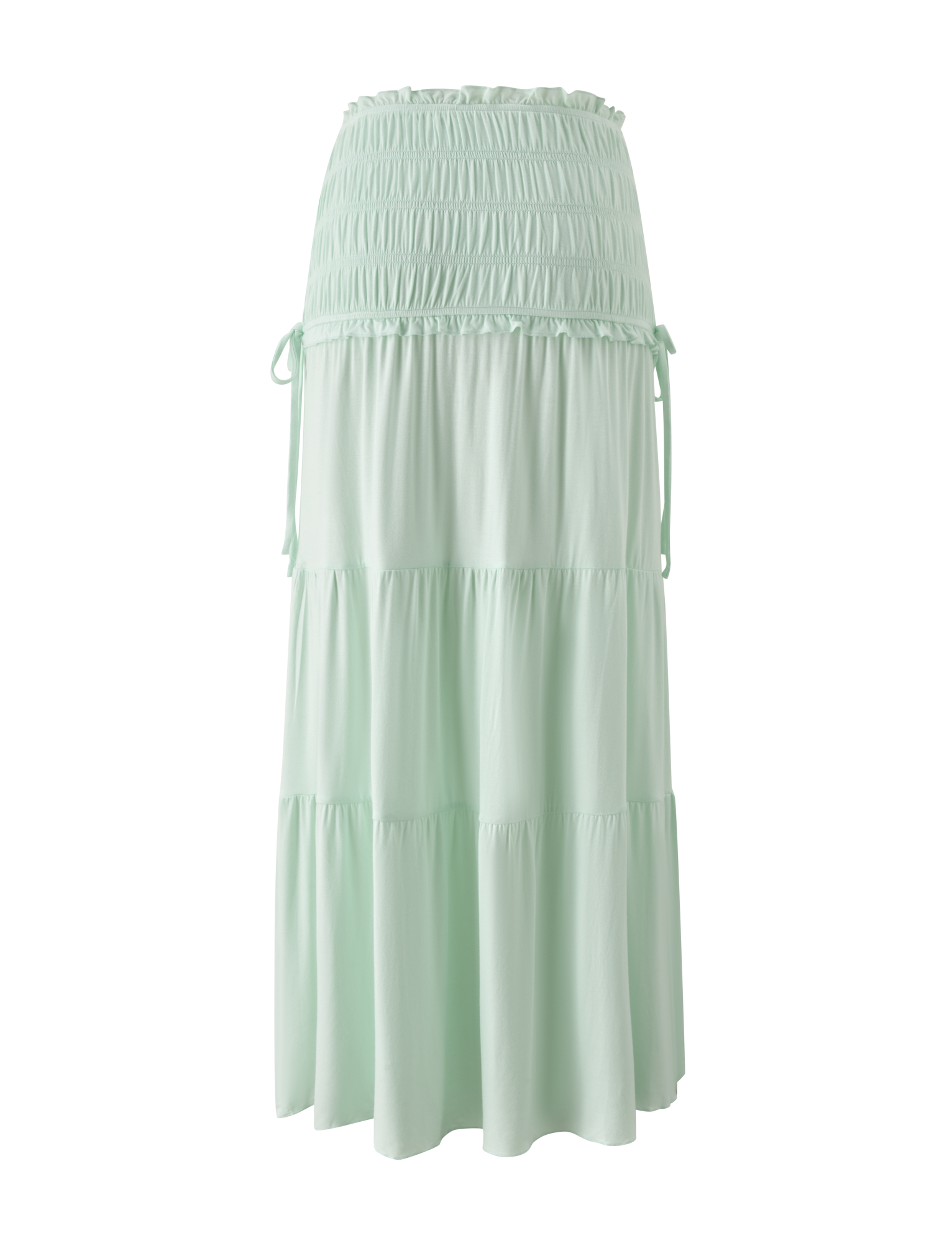 The DENALI MAXI SKIRT - SOFT MINT by TIGERMIST is a flowy modal maxi skirt with a wide shirred waistband, tiered silhouette, subtle ruffles, and side ties.