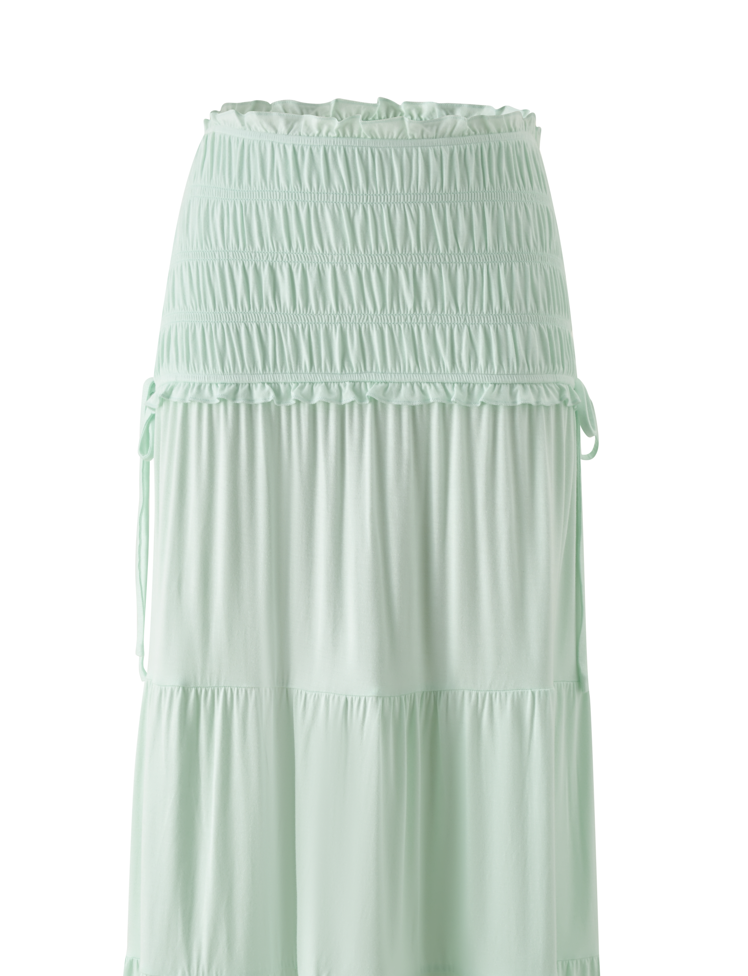The TIGERMIST DENALI MAXI SKIRT in Soft Mint features a wide shirred elastic waistband, soft modal fabric, subtle ruffle tiers, and side drawstrings for an effortlessly flowy style.
