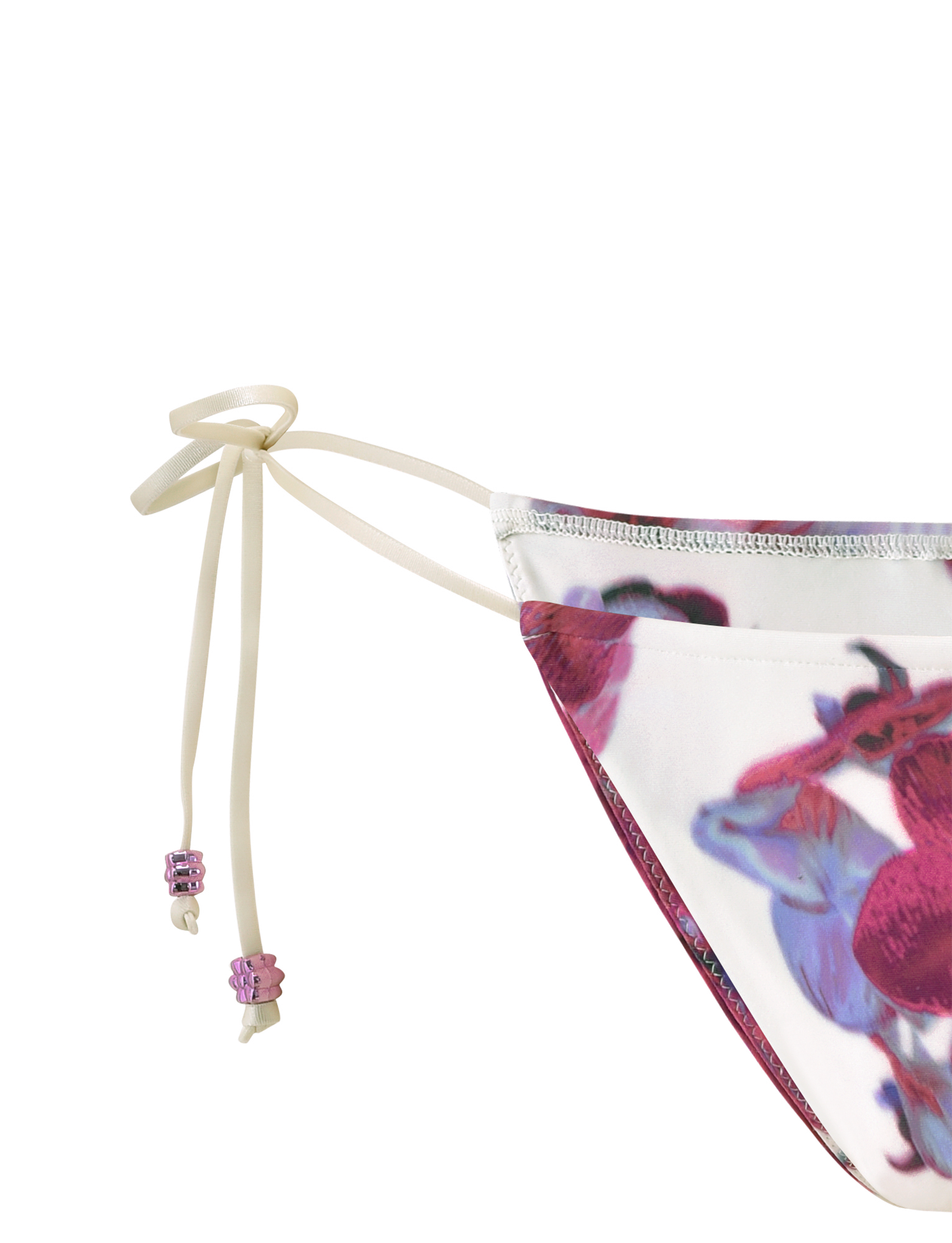 Close-up of the TIGERMIST AVE BIKINI BOTTOM - ORCHID HAZE, showcasing its red and purple floral print, cream tie strings with pink beads, all set against a white background.
