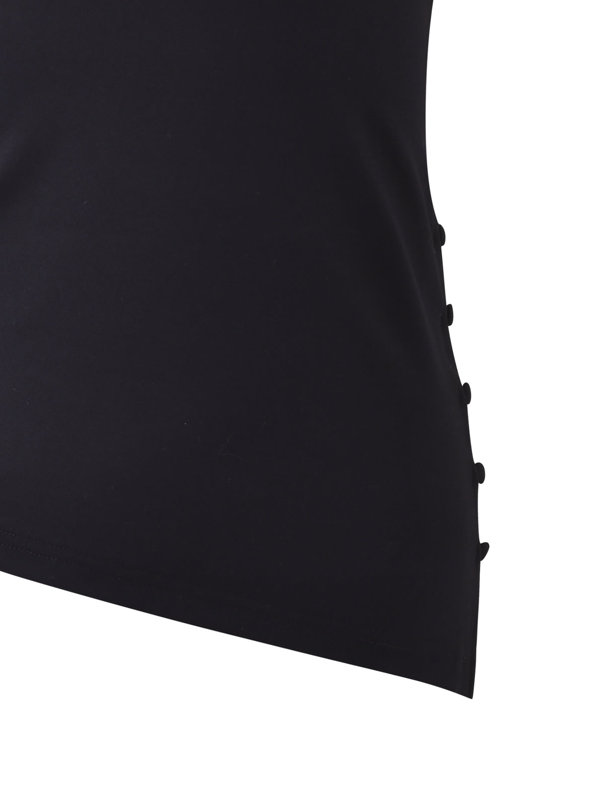 Close-up of the INDIRA TOP - BLACK by TIGERMIST, highlighting the side seam adorned with a row of small, round black buttons for fastening. The smooth and slightly stretchy fabric suggests a form-fitting design. The background is white.