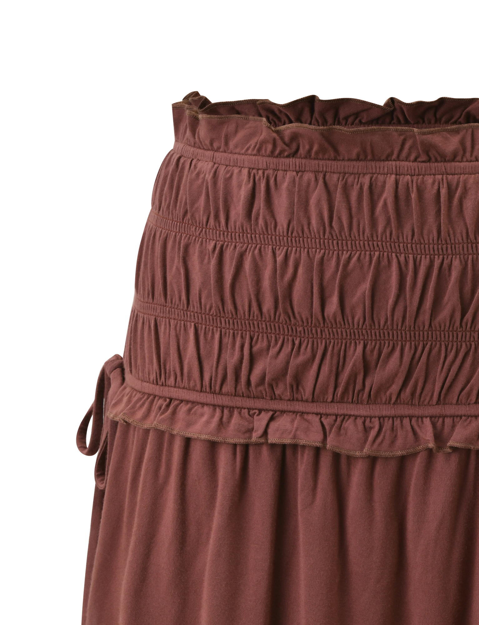 Close-up of the DENALI MINI SKIRT - CHOCOLATE by TIGERMIST, featuring a wide shirred waistband, top ruffle trim, side tie detail, and soft fabric with gentle gathers below the waist.