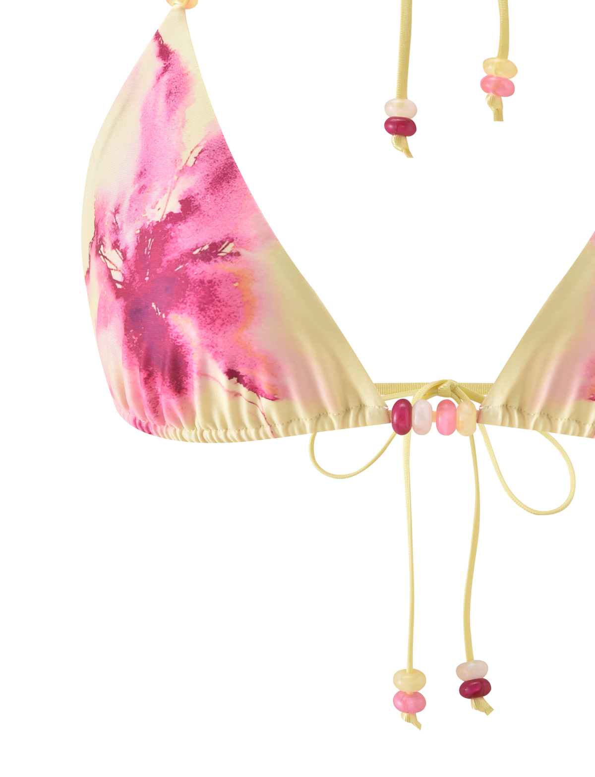 Close-up of the FINLEA BIKINI TOP - WATERCOLOUR FLORAL by TIGERMIST. Features a yellow and pink tie-dye pattern, adjustable halter neck, and beaded strings in pink, yellow, and white. Set against a plain white background.