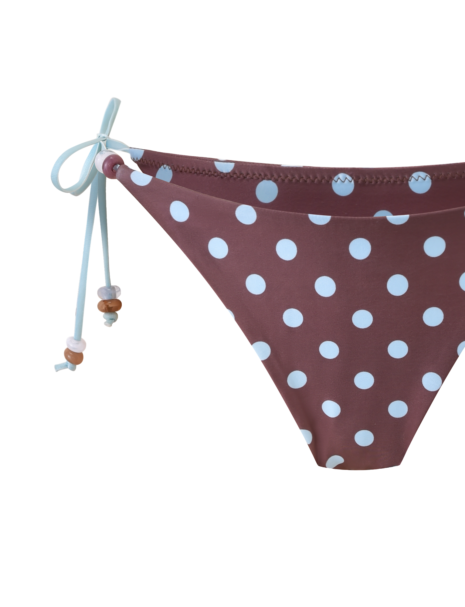 The FINLEA BIKINI BOTTOM by TIGERMIST features a brown base with blue polka dots and light blue beaded side ties, shown against a plain white background.