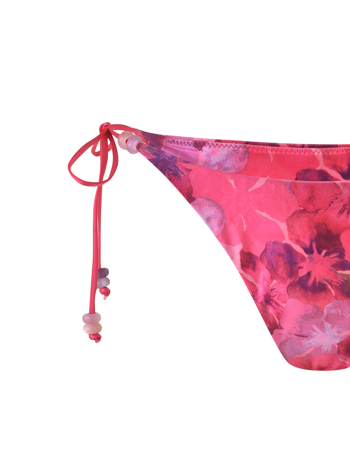 Close-up of the TIGERMIST FINLEA BIKINI BOTTOM - PINK : HIBISCUS, a cheeky bikini cut with purple and pink hibiscus floral patterns and pink/purple beaded side ties, set against a white background.