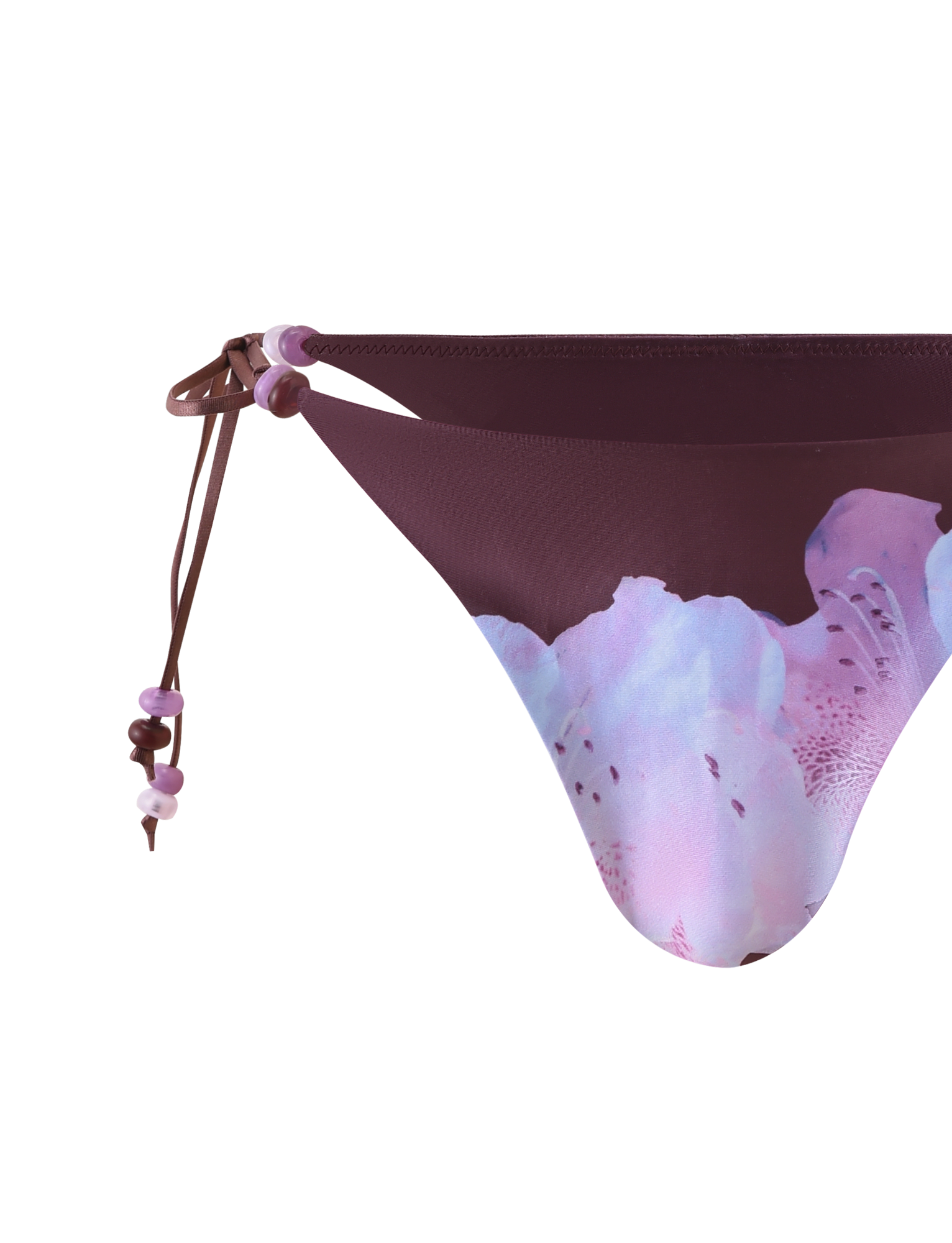 Close-up of the TIGERMIST FINLEA BIKINI BOTTOM - ZEN FLORAL in light pink and purple hues, featuring a plum floral print and adjustable brown bikini straps with small pink and purple beads. Background is plain white.