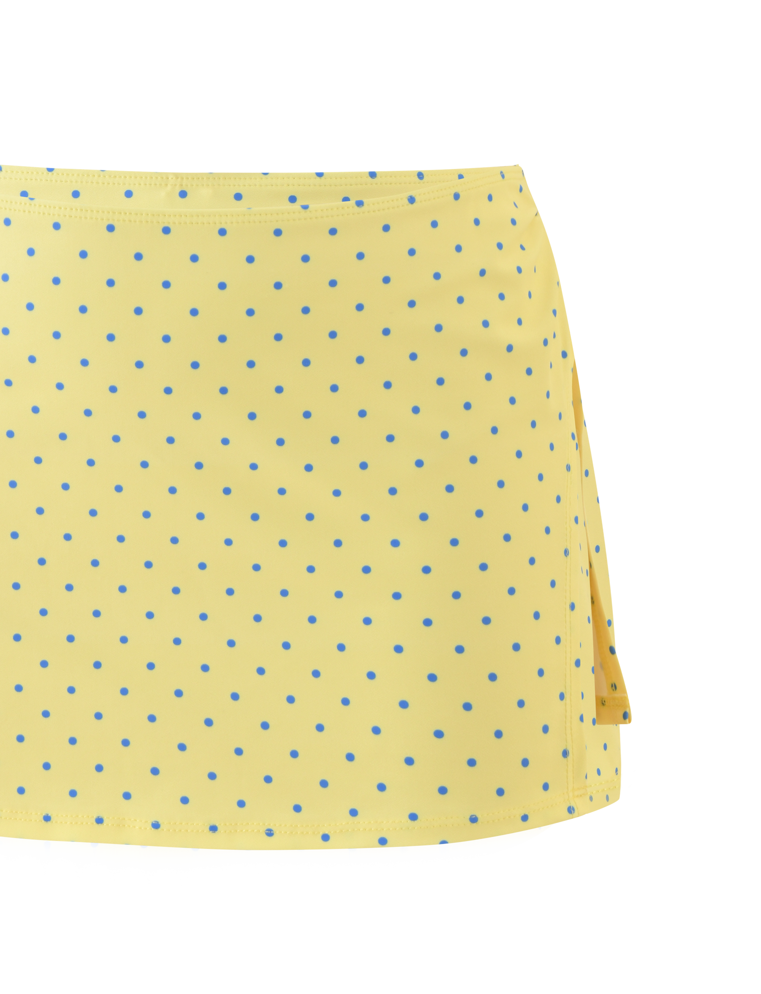A close-up of the TIGERMIST DIANA SWIM SKIRT SET in Lemon and Blueberry Spot, showcasing yellow fabric with blue polka dots and a right side slit against a white background.